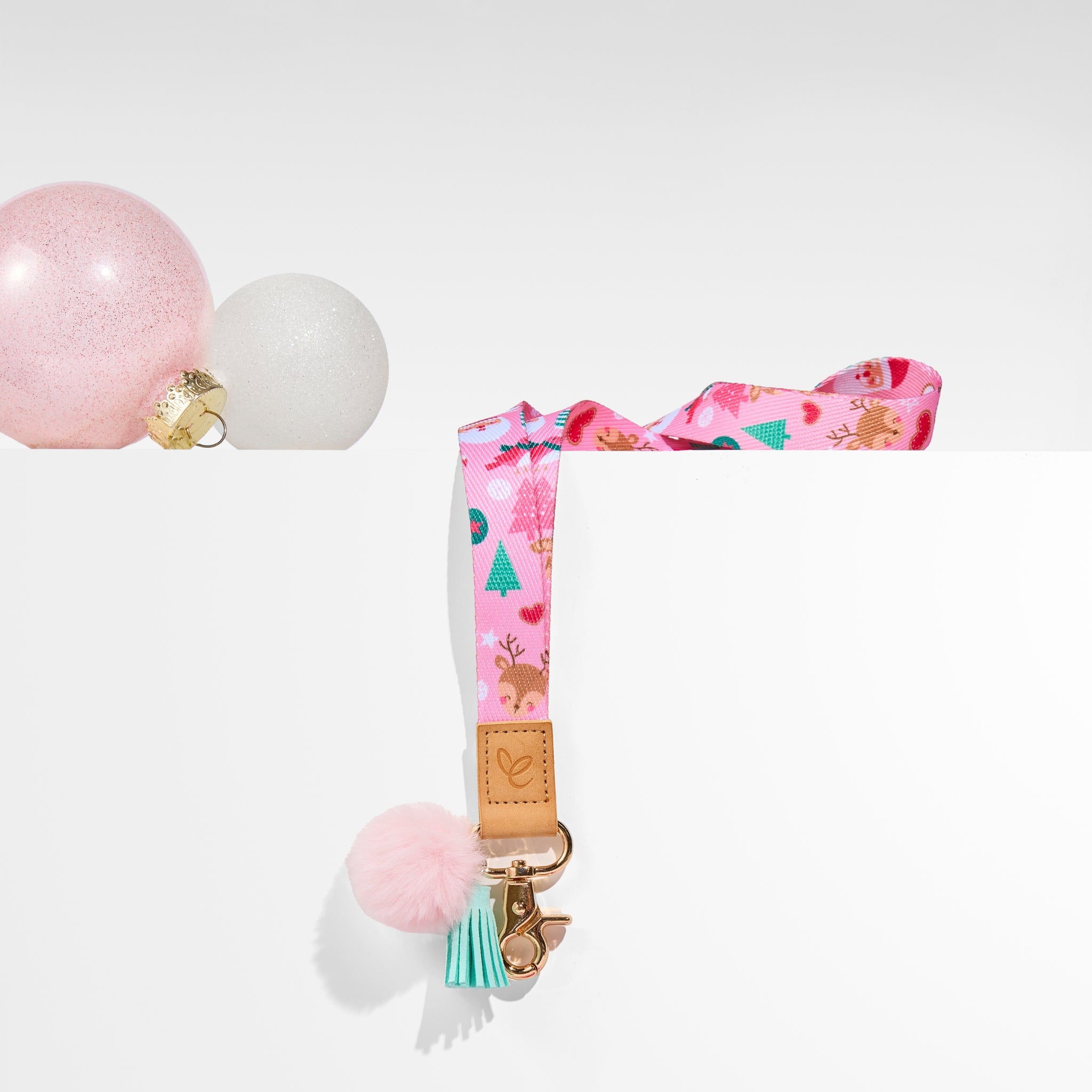 Pastel pink Christmas lanyard with festive prints, pom-pom, tassel, gold clasp, and 'Mrs Edgar' patch. Comes with gift box and card.