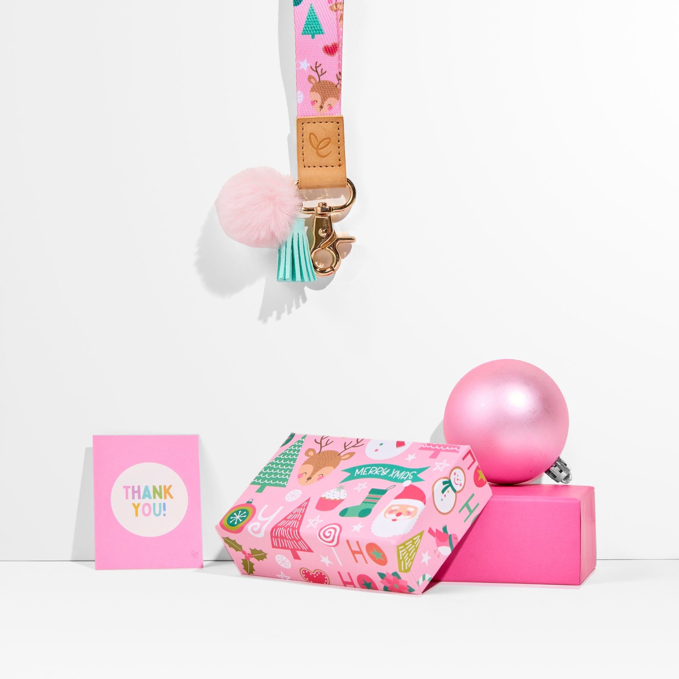 Pastel pink Christmas lanyard with festive prints, pom-pom, tassel, gold clasp, 'Mrs Edgar' patch, and breakaway clasp.