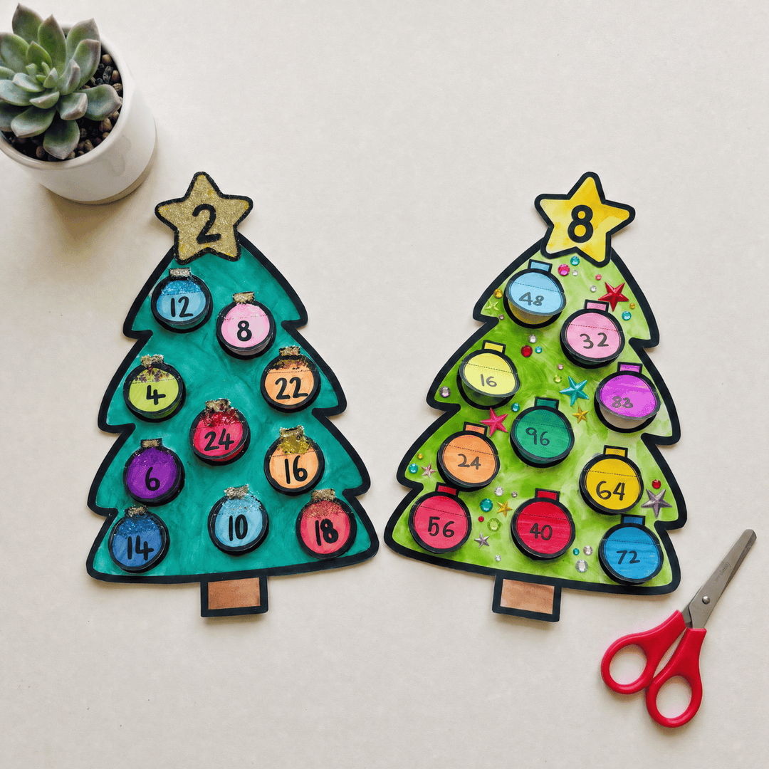 Two completed Christmas tree multiplication craftivities decorated with coloured baubles showing times table answers
