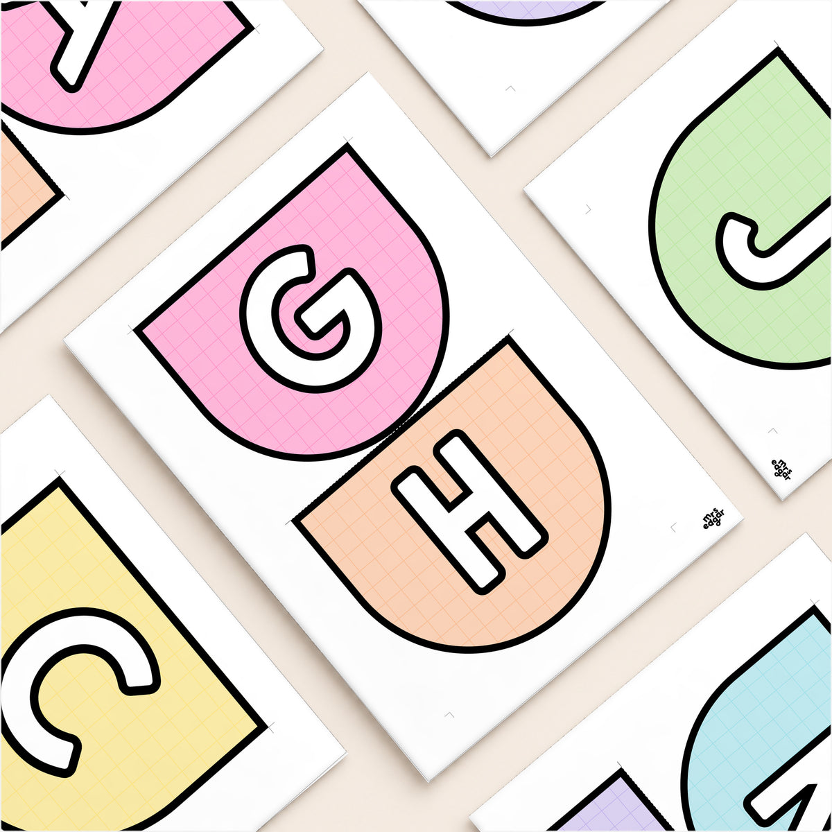 Flat lay of printed classroom bunting pennants - letters, numbers and pictures in arched and swallowtail shapes