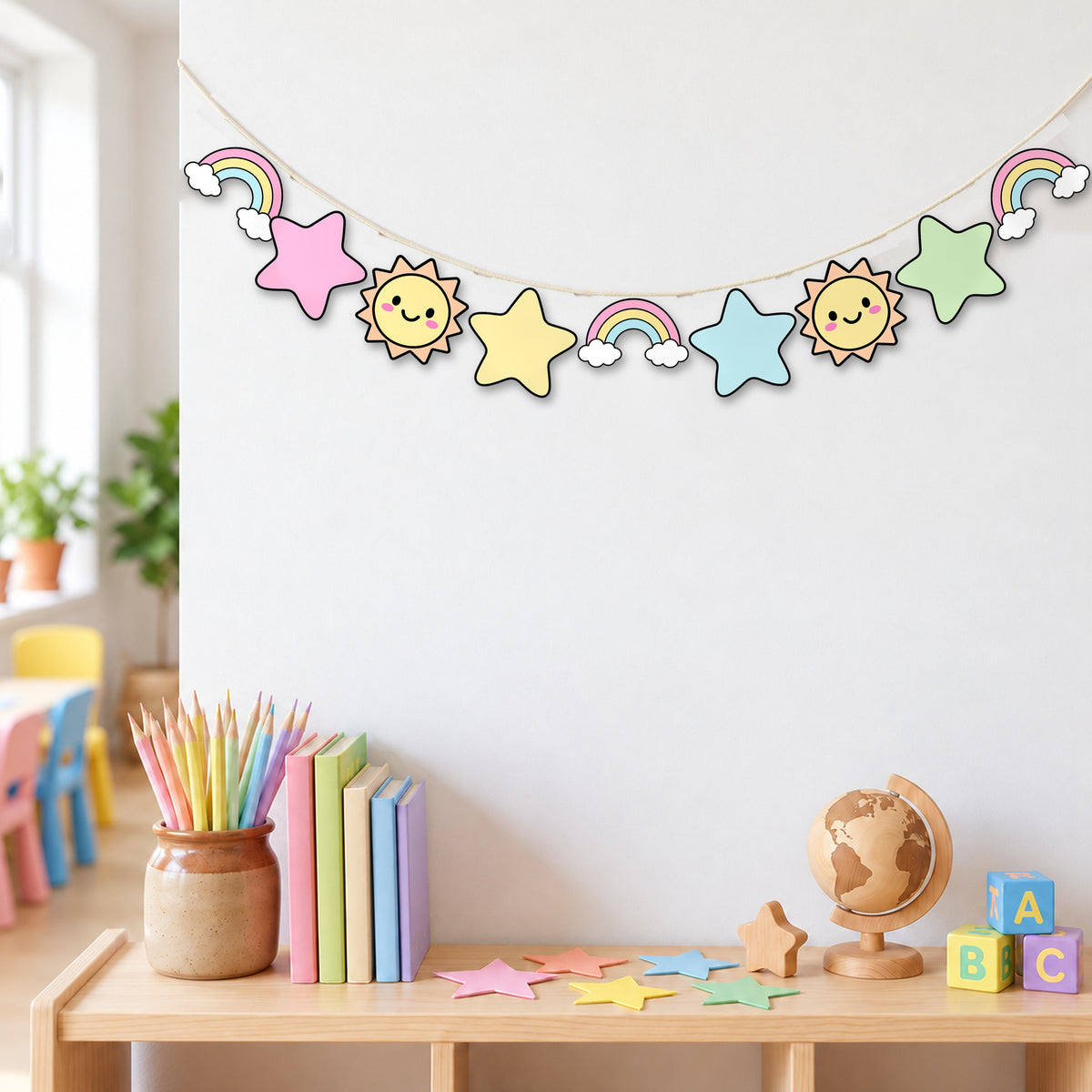 Clipart garland of rainbows, stars and suns strung across a classroom wall