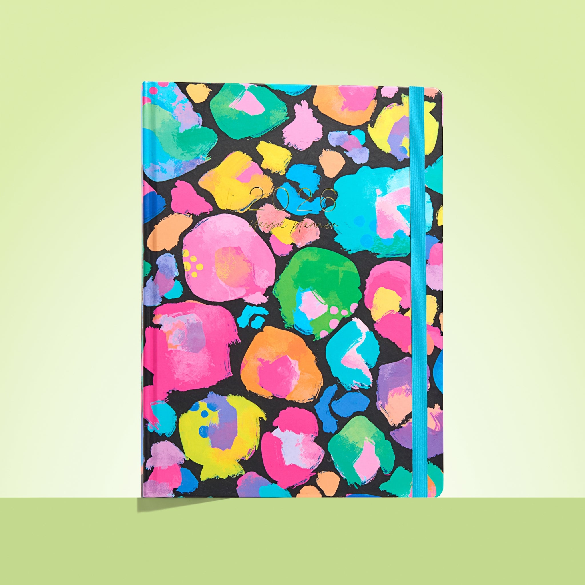 Notebook with colorful abstract pattern on a light green background