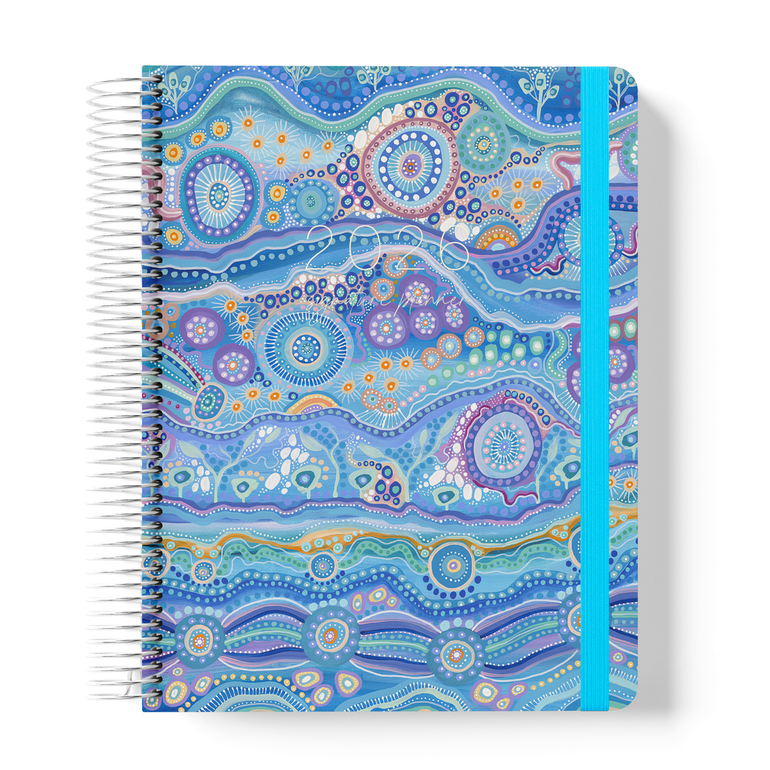 2026 teacher planner featuring a vibrant, ocean-inspired Indigenous artwork cover with teal elastic closure and white coil binding.