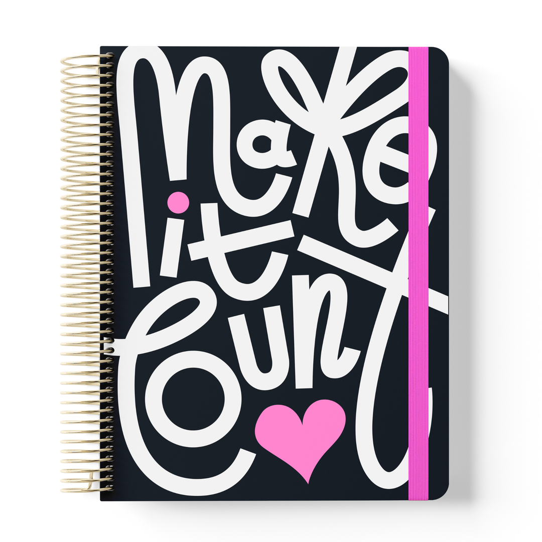 2026 teacher planner with bold black cover, white hand-lettered “Make it count” text, pink heart, gold coil, and pink elastic strap.