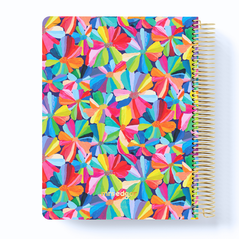 2026 teacher planner with a bold floral cover featuring hand-painted rainbow petals and gold coil binding