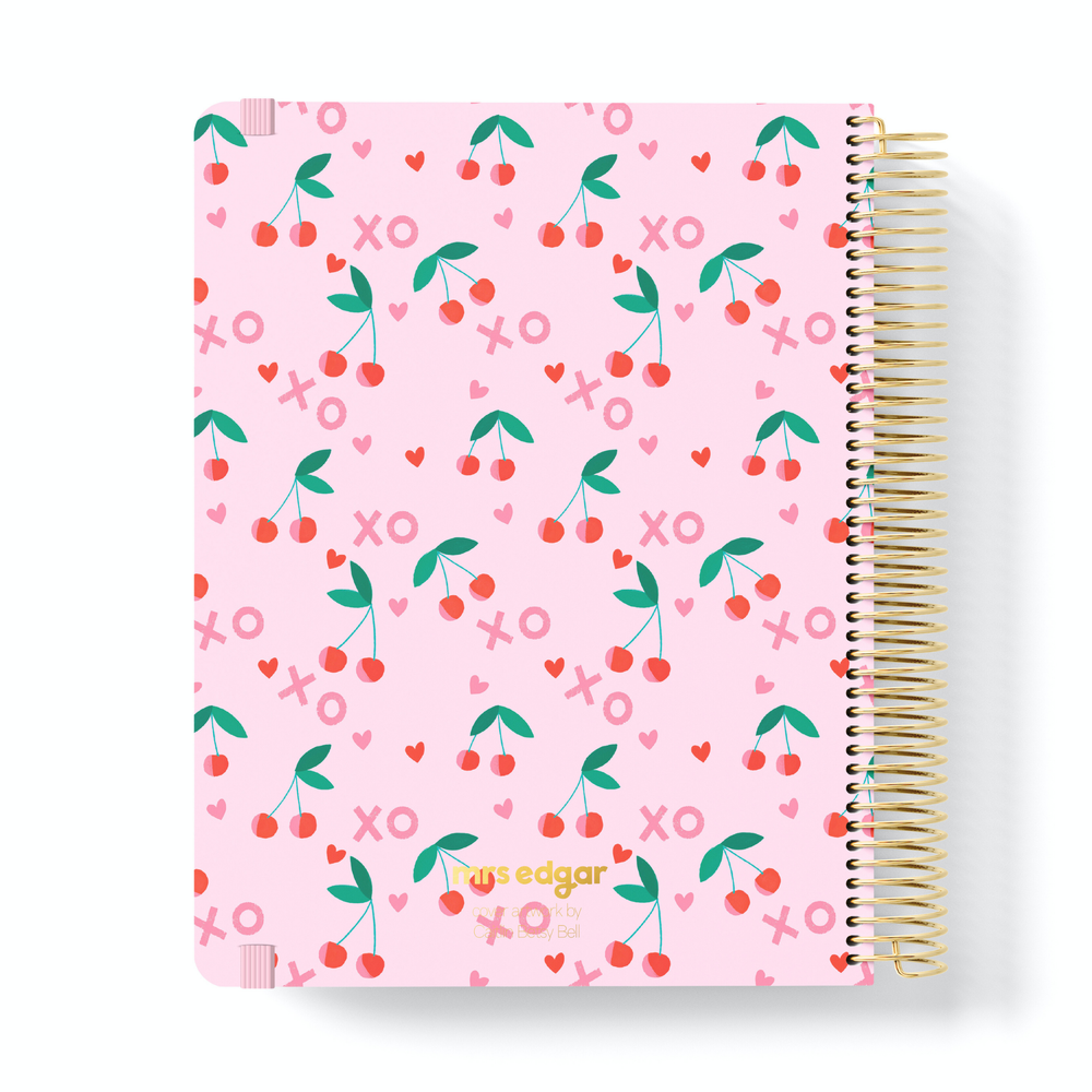 Pink 2026 planner with red cherry, heart, and “XO” pattern, featuring “mrs edgar” text at the bottom in gold.
