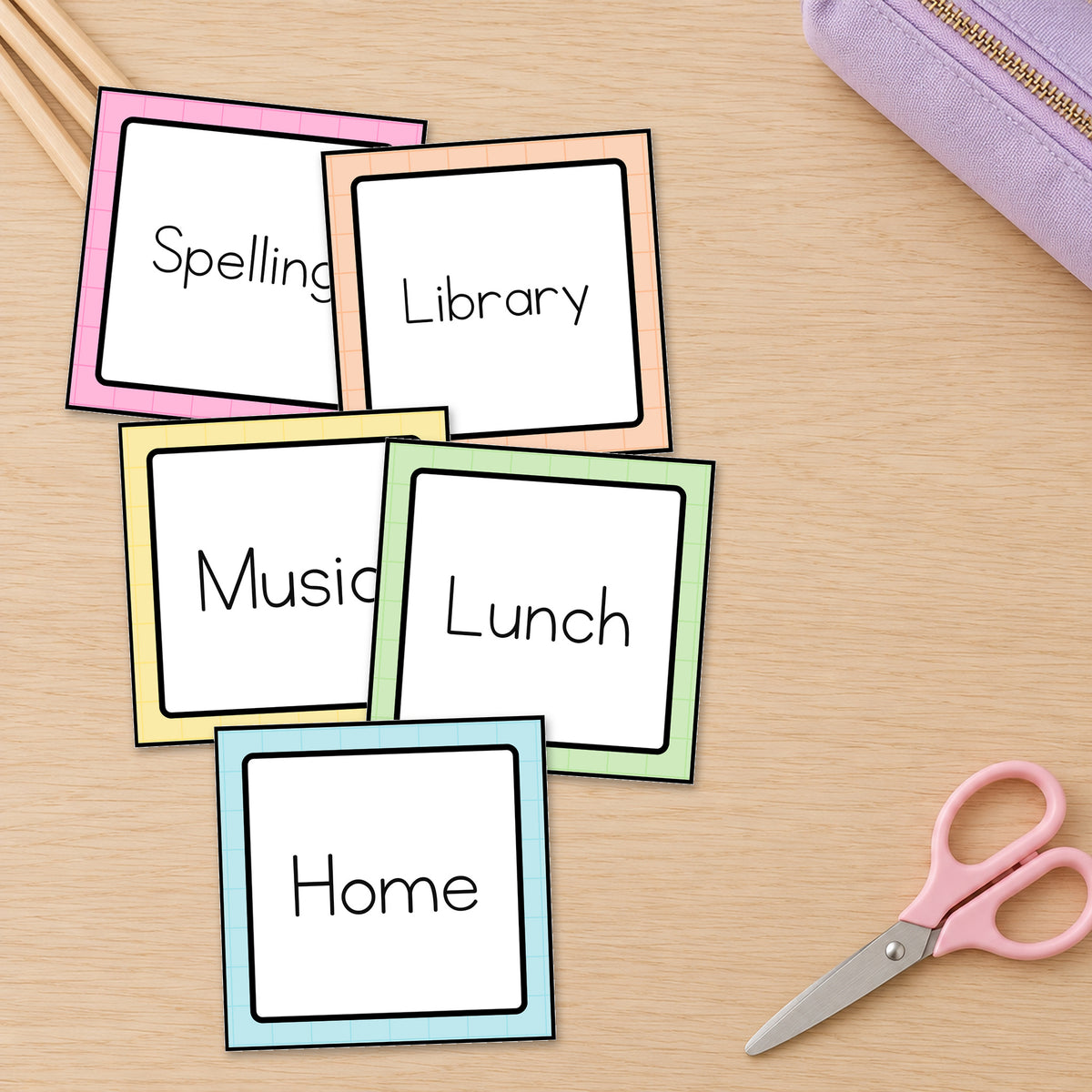 Editable classroom labels on a teacher's desk, six Gentle colours