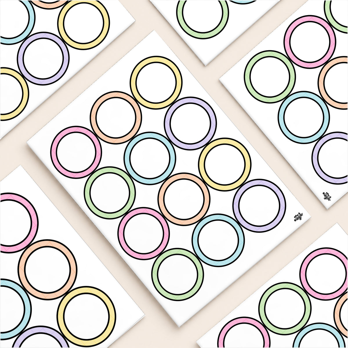Flat lay of printed circle name tags in six Gentle colours