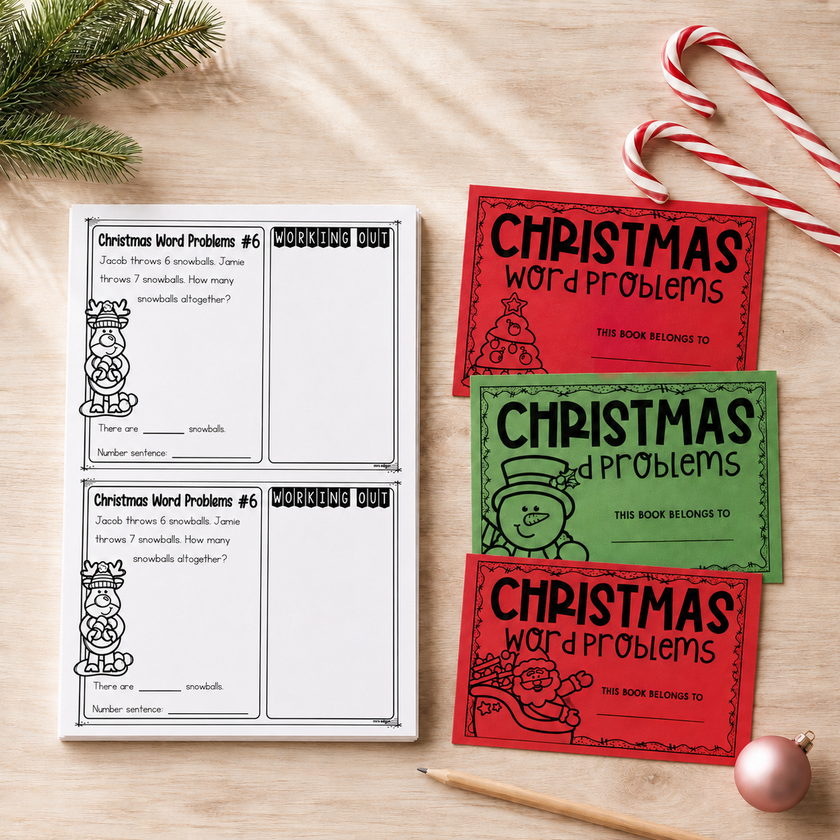 Year 1 Christmas word problem task cards fanned out beside the red and green covers.
