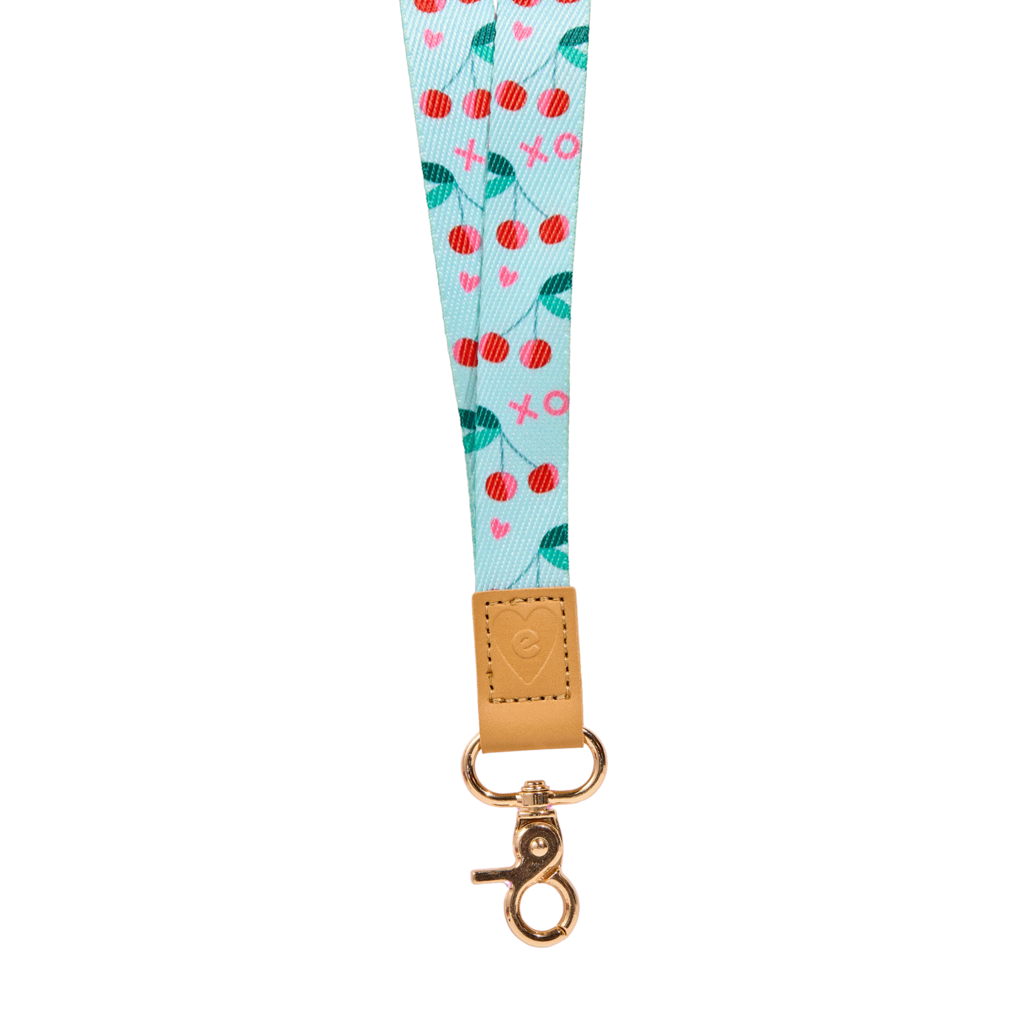 Mint cherry print fabric lanyard with red cherries, green leaves and small pink heart details, tan leather tab with embossed heart logo, and gold clasp, isolated on a clean white background