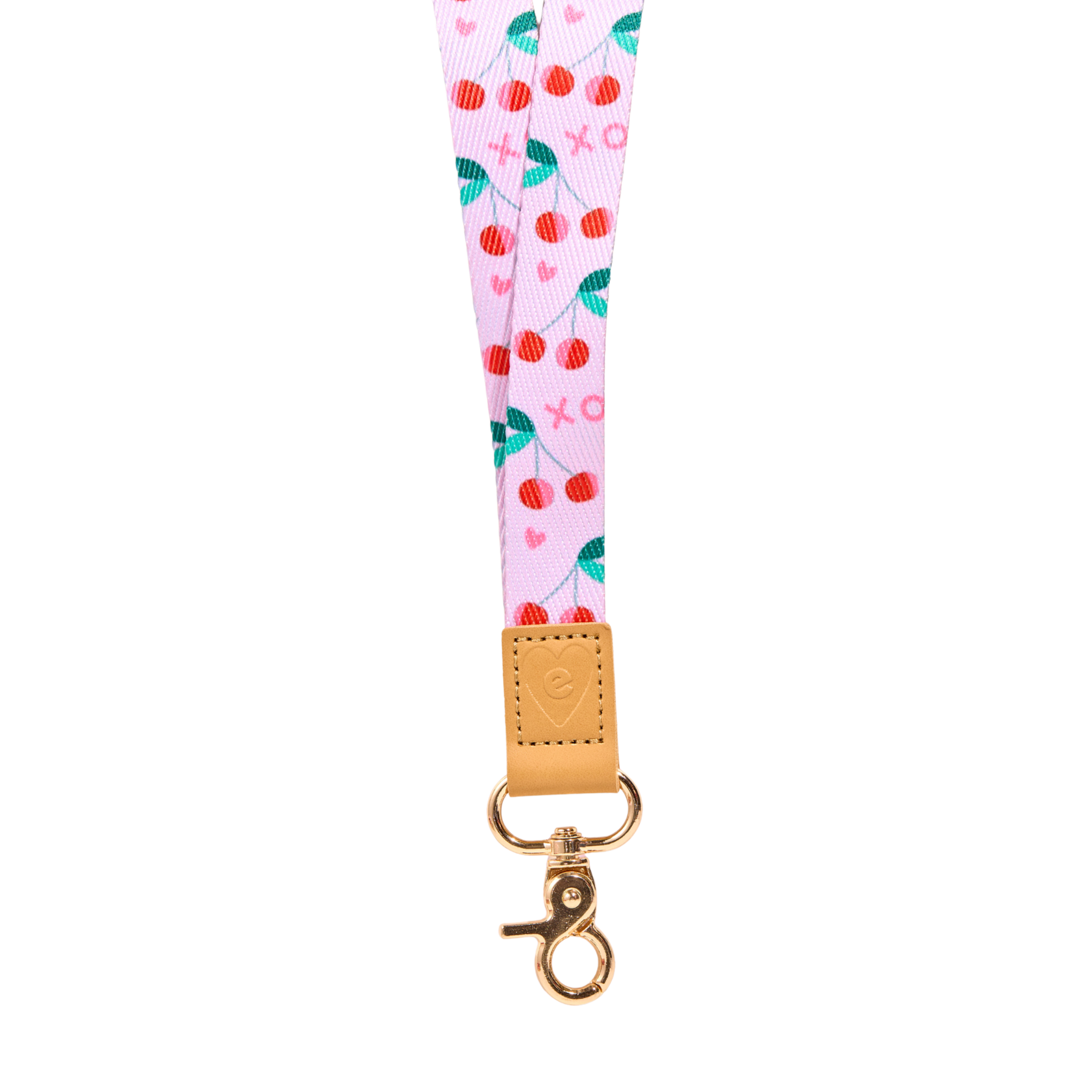 Pink cherry print fabric lanyard with red cherries, green leaves and small heart details, tan leather tab with embossed heart logo, and gold clasp, isolated on a clean white background