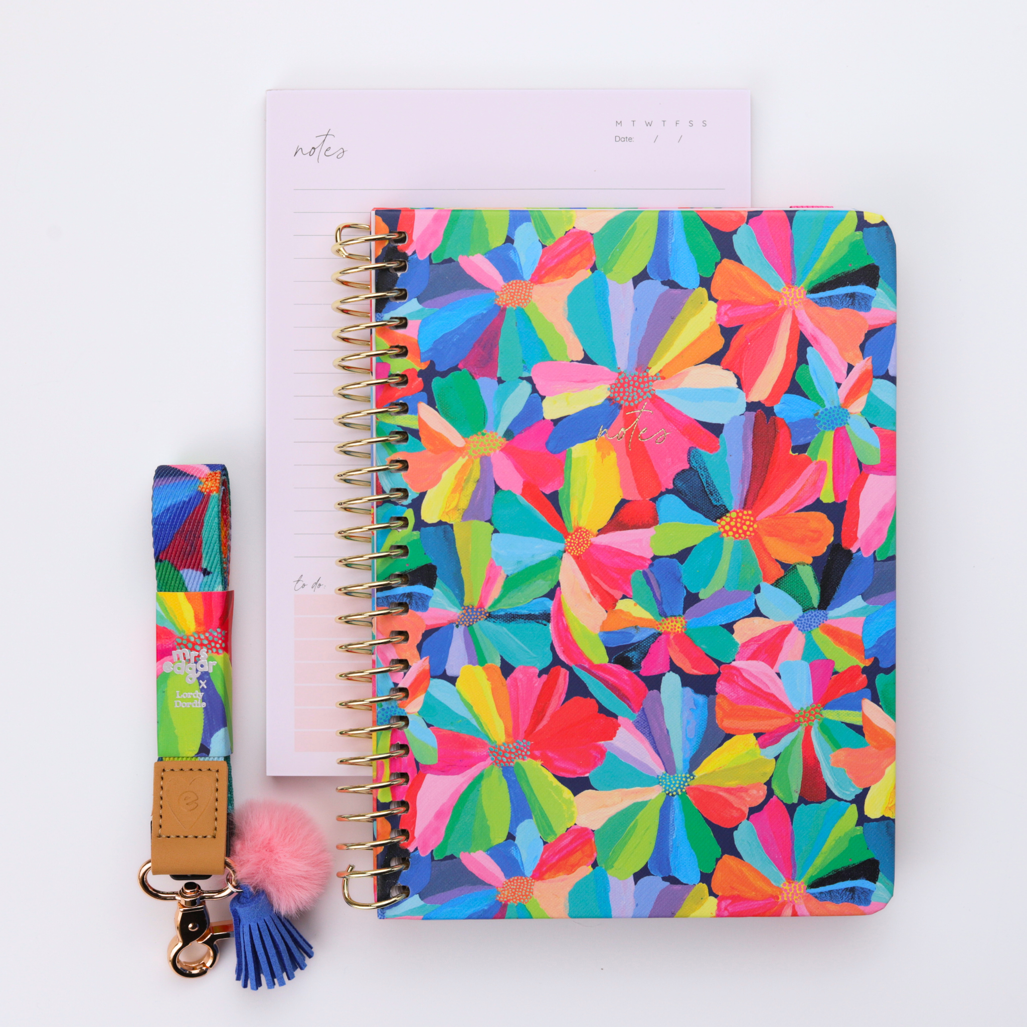 Colourful floral A5 teacher notebook with pink elastic band and matching lanyard styled with a pastel lined notepad