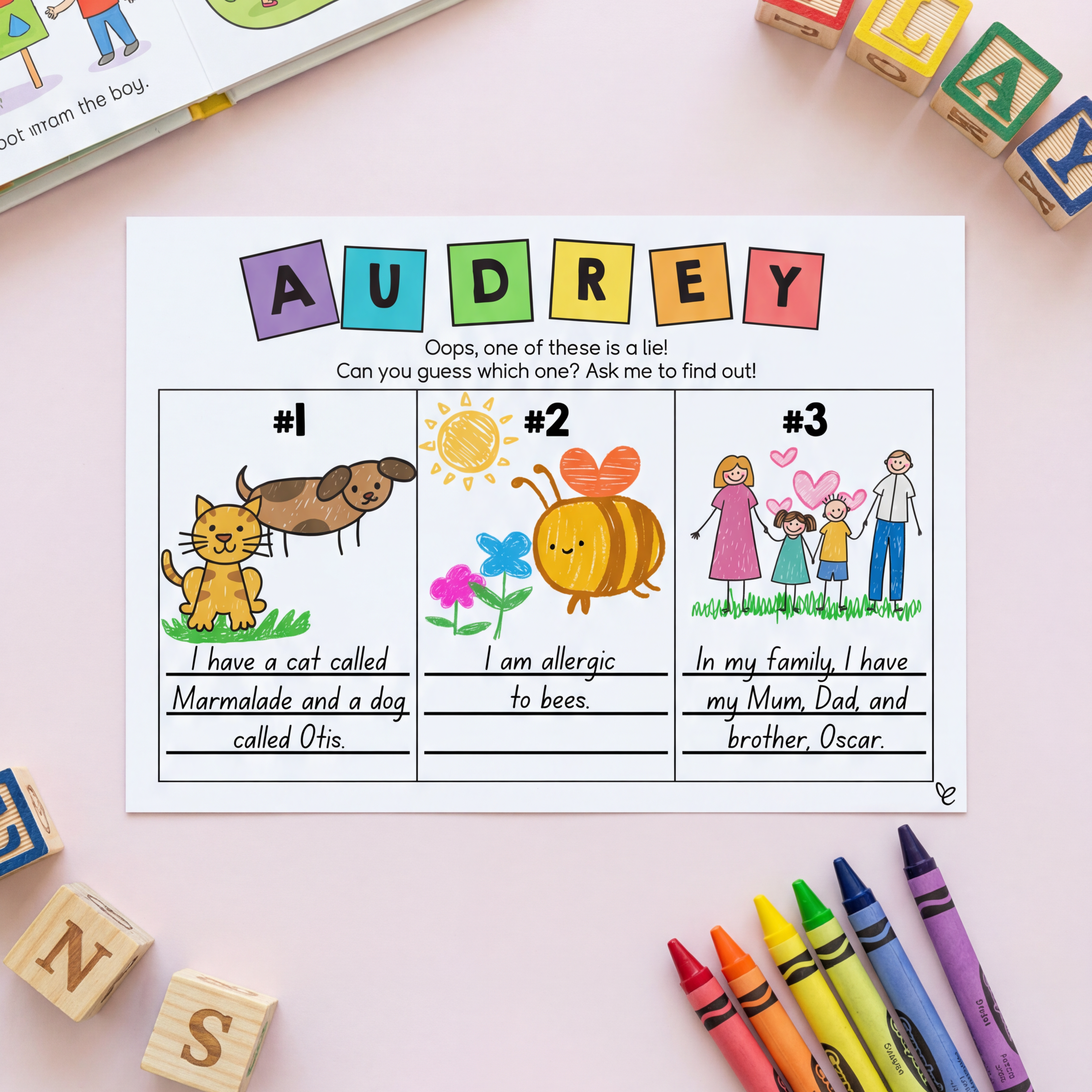 A completed "Two Truths and a Lie" worksheet with a child's name "Audrey" in colourful letter cutouts, three illustrated statements, and crayons beside the page.
