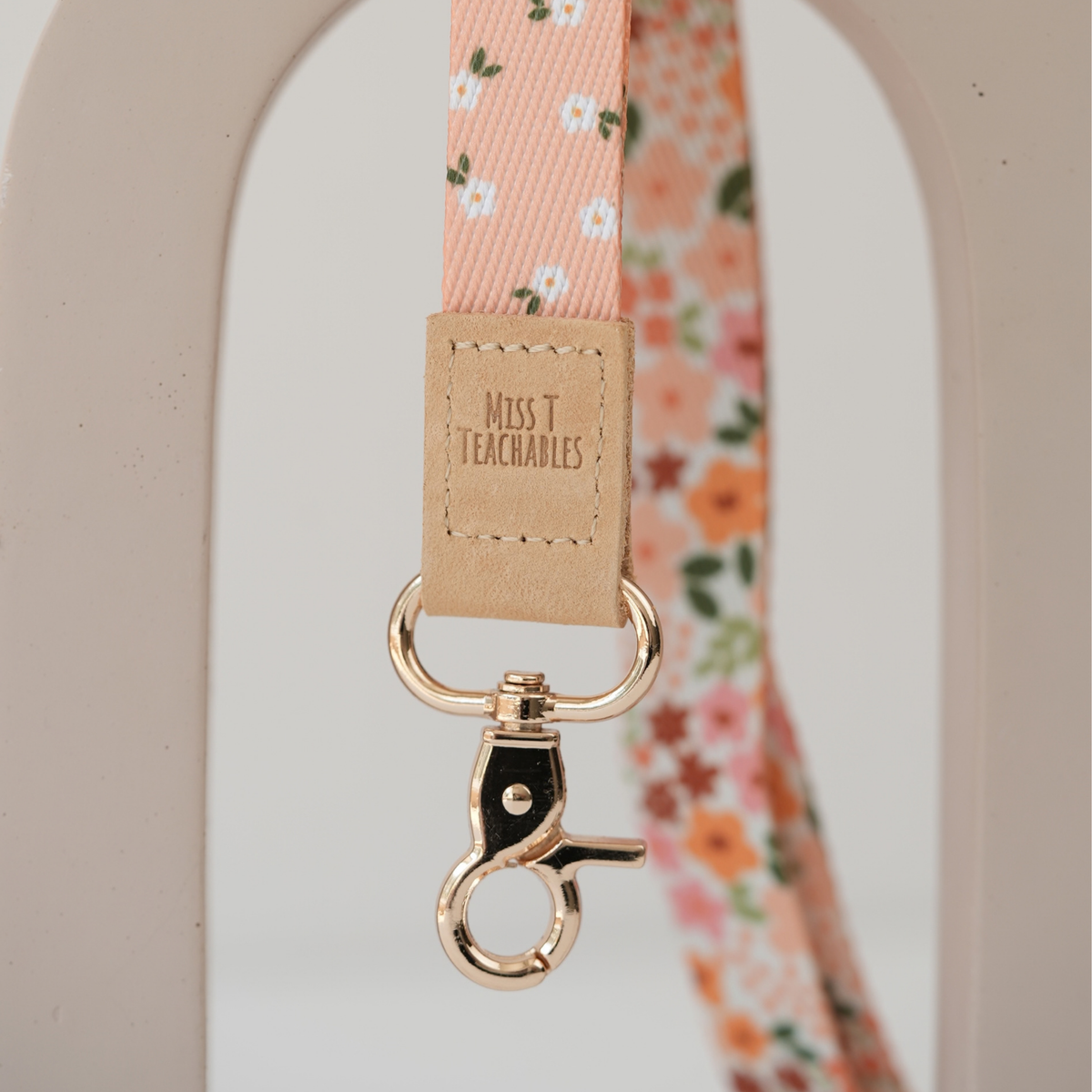 Detail of Boho Ditsy Floral reversible lanyard showing both cream floral and peach daisy sides