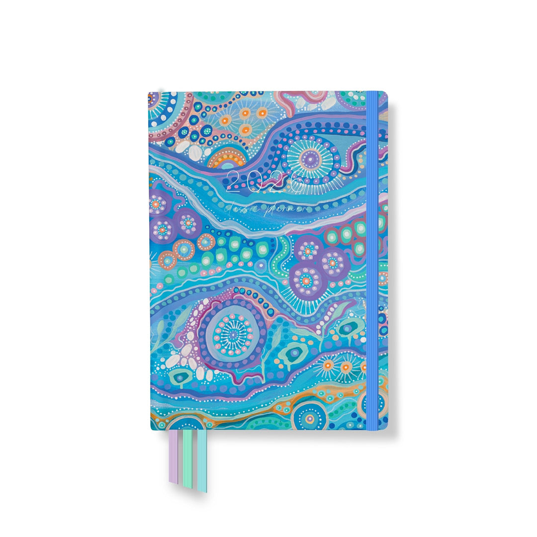 2026 Coastal Connections planner front cover featuring a colourful flowing design with a blue elastic closure and two ribbon markers.