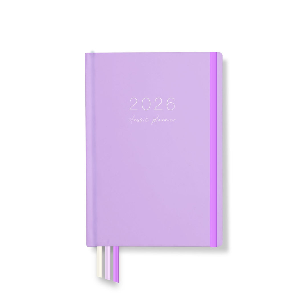 2026 classic planner front cover in soft lilac with white text, matching elastic closure, and three ribbon page markers.