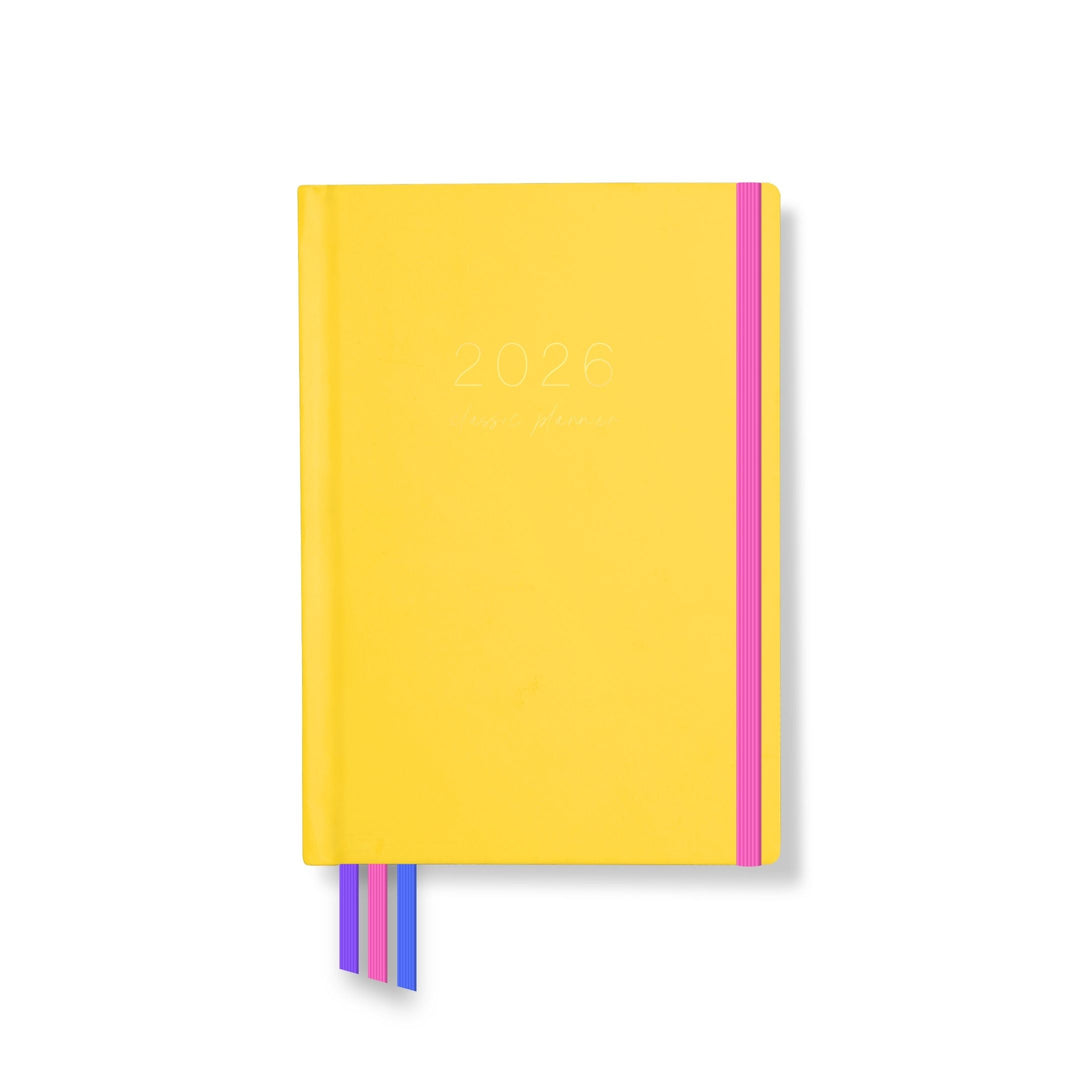 2026 classic planner front cover in vibrant marigold yellow with pink elastic closure and three colourful ribbon markers.
