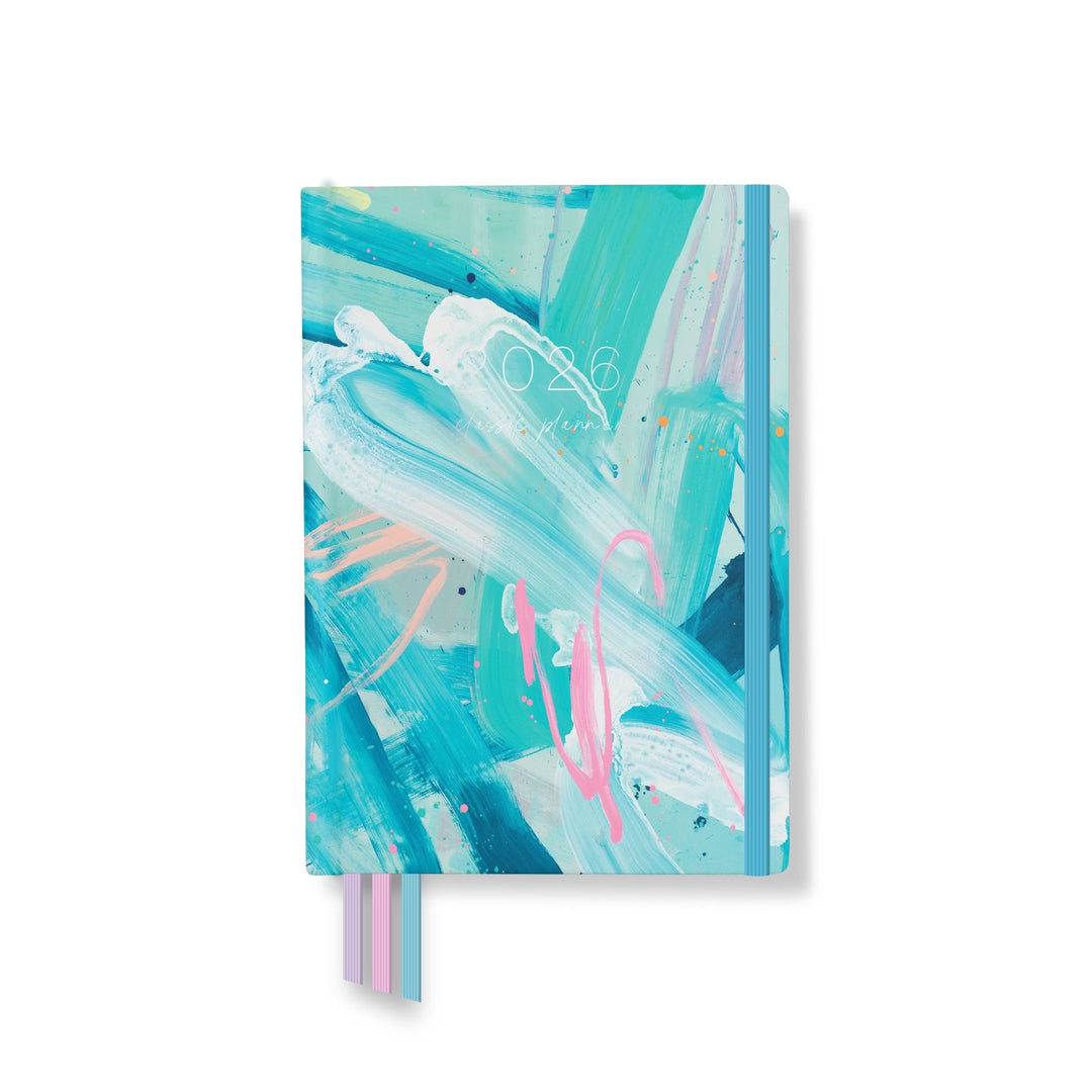 2026 classic planner front cover featuring vibrant abstract brushstrokes in teal, pink, and white, with a teal elastic and ribbon markers.
