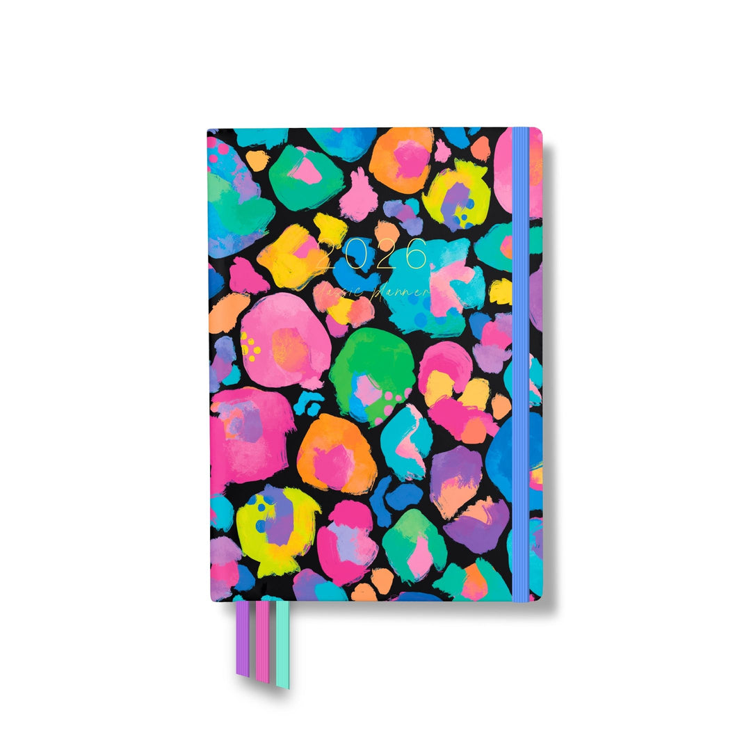 2026 classic planner front cover with vibrant rainbow leopard print on a black background, blue elastic, and colourful ribbon markers.