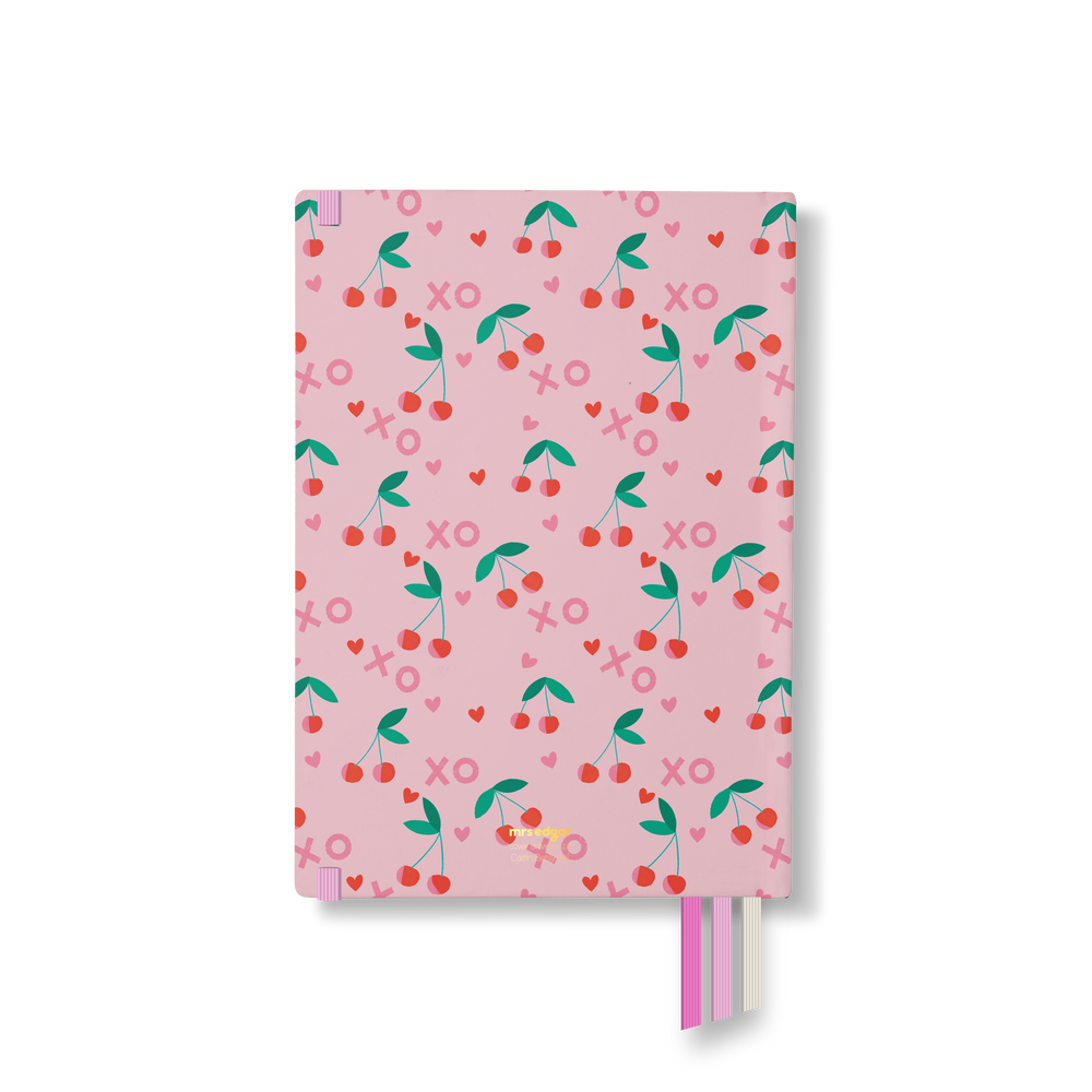 Back cover of 2026 planner with a repeating cherry, XO, and heart pattern on light pink, featuring pink, cream, and red ribbon bookmarks.