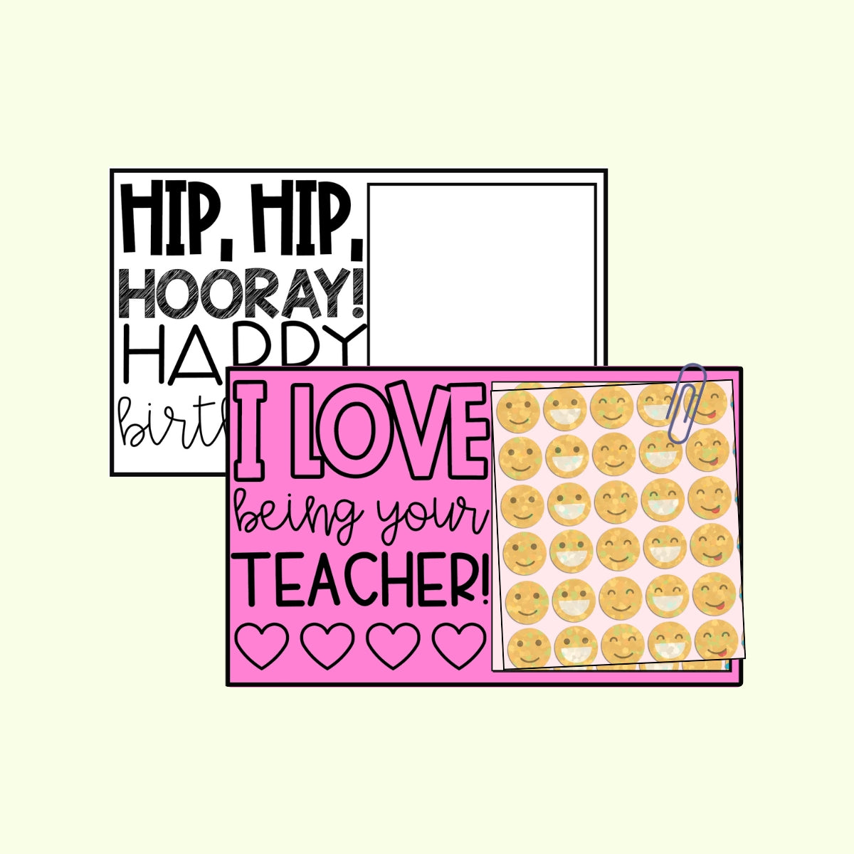 A crafting scene with a black and white birthday sign, a pink teacher appreciation sign reading "I LOVE being your TEACHER!" with heart designs, and a clipped sheet of smiley face stickers. Scissors and notebook paper are also visible.
