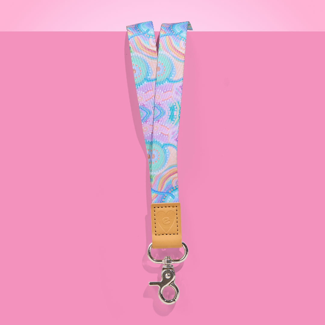 Teacher Lanyard with colourful pattern and brown leather strap on pink background
