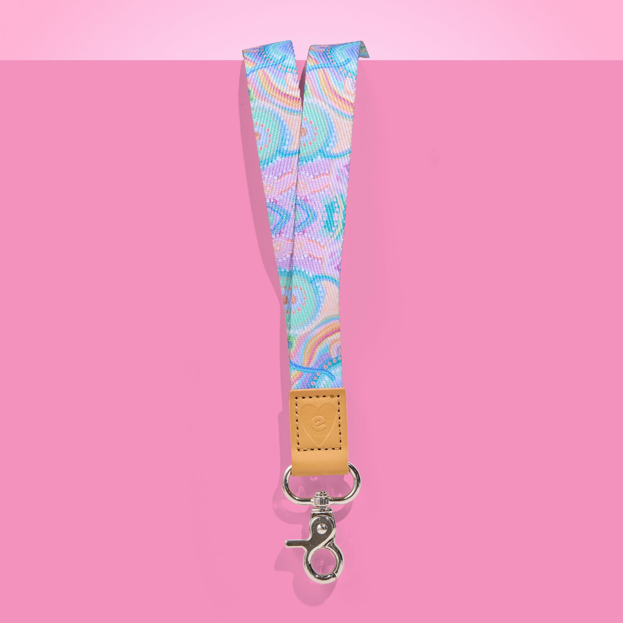 Teacher Lanyard with colourful pattern and brown leather strap on pink background