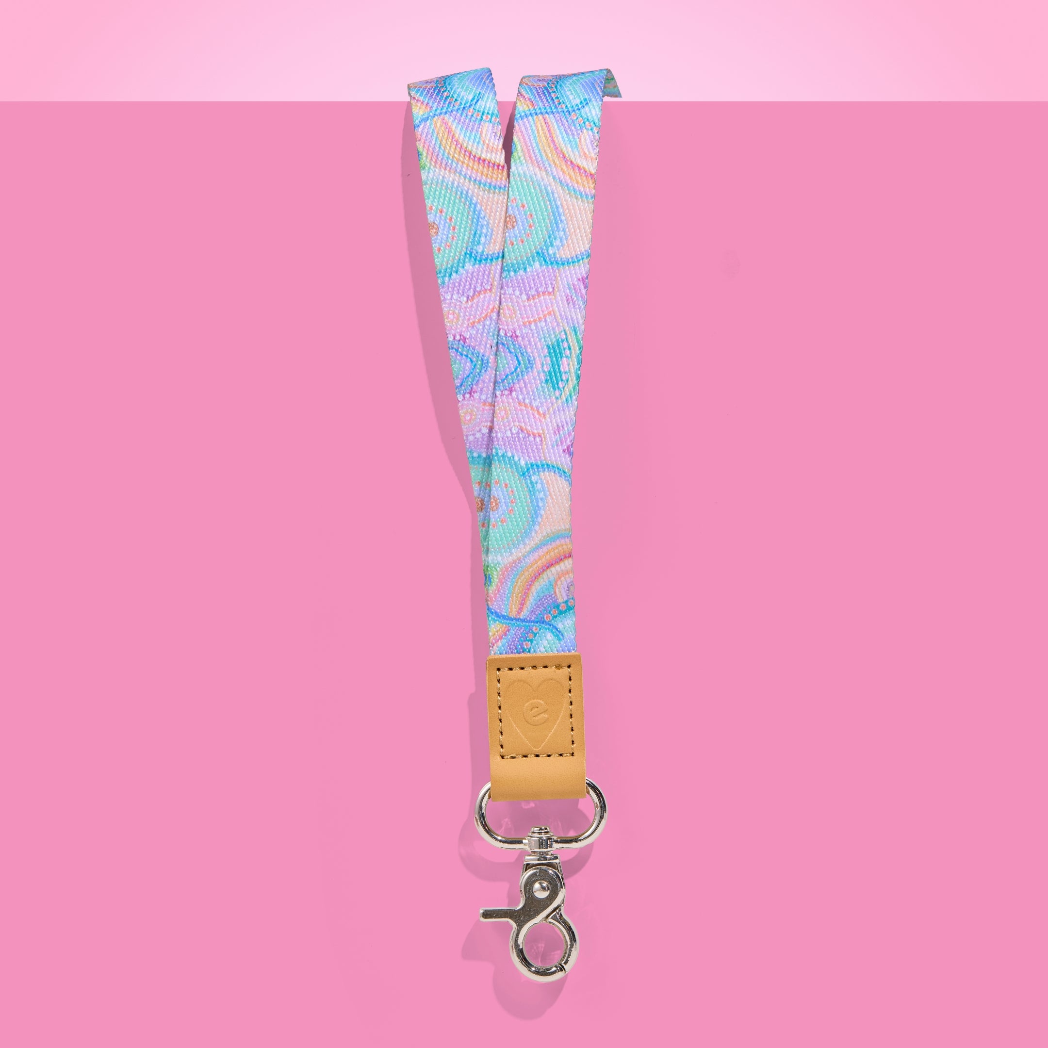 Teacher Lanyard with colourful pattern and brown leather strap on pink background
