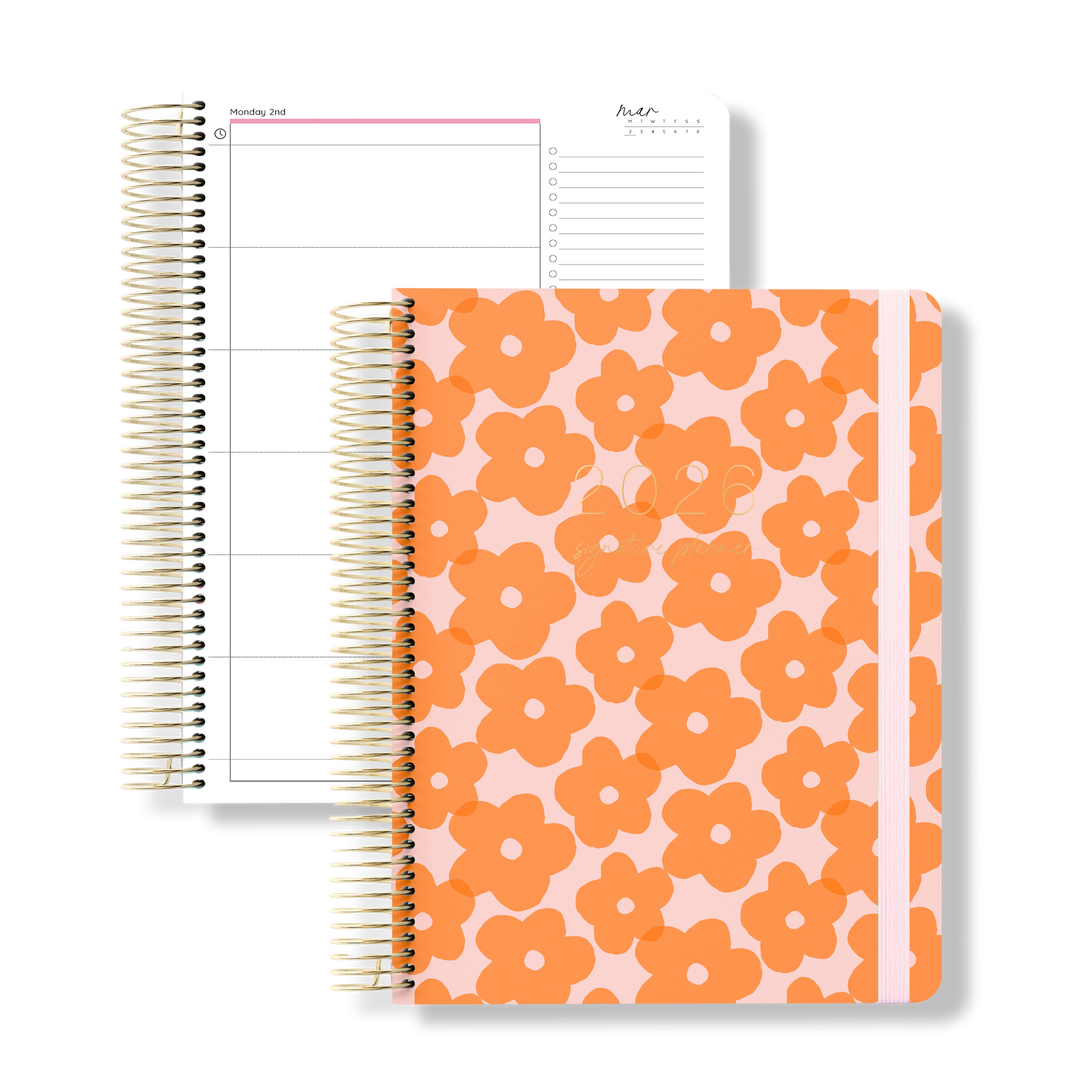 Flat lay of the 2026 teacher planner with a playful orange flower print on the back cover, next to a structured daily planning page.