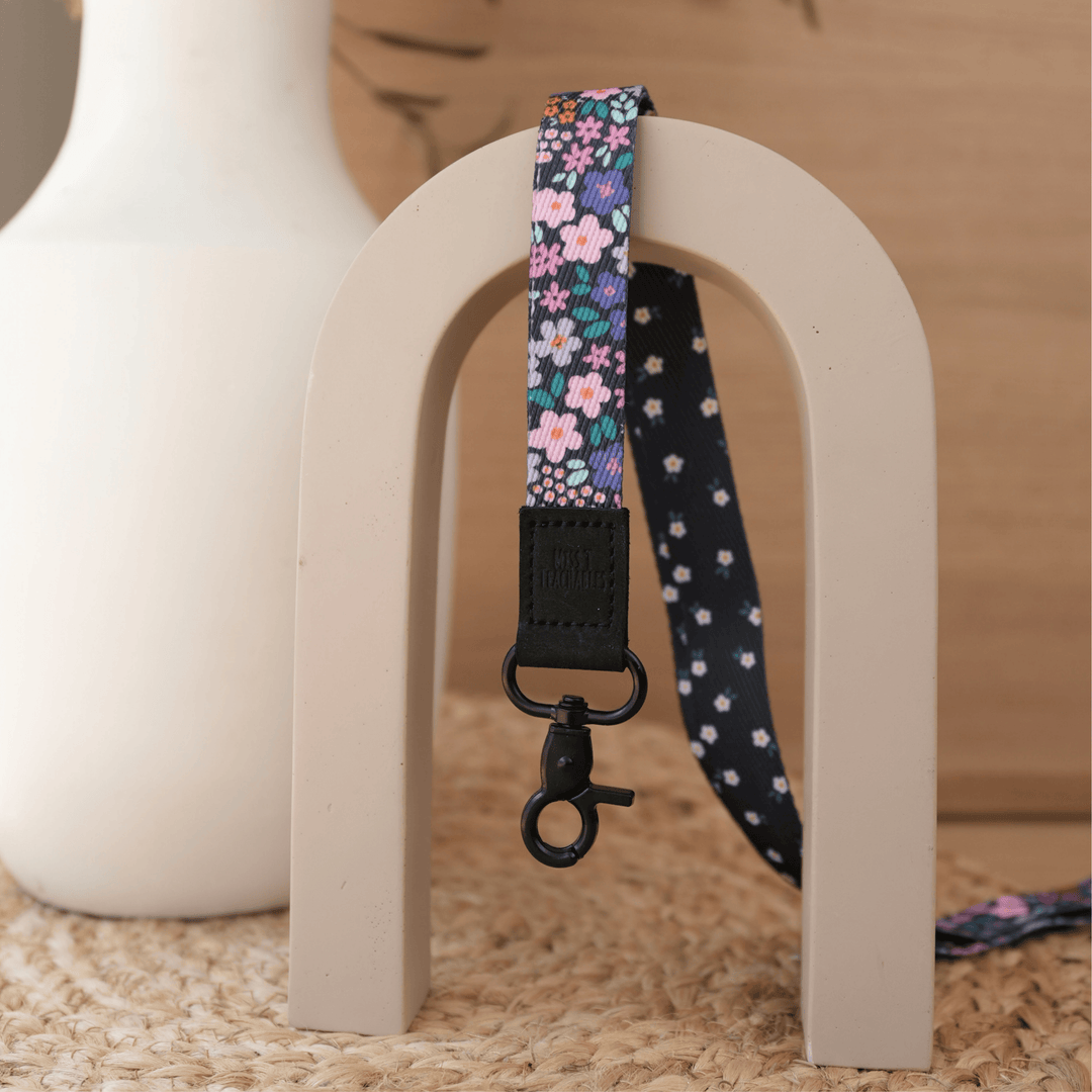 Dark Ditsy Floral reversible teacher lanyard, navy floral front with white daisy reverse and matte black clasp