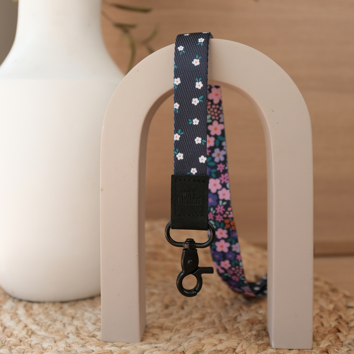 Dark Ditsy Floral teacher lanyard reversed to show the navy ditsy daisy print with black leather tab