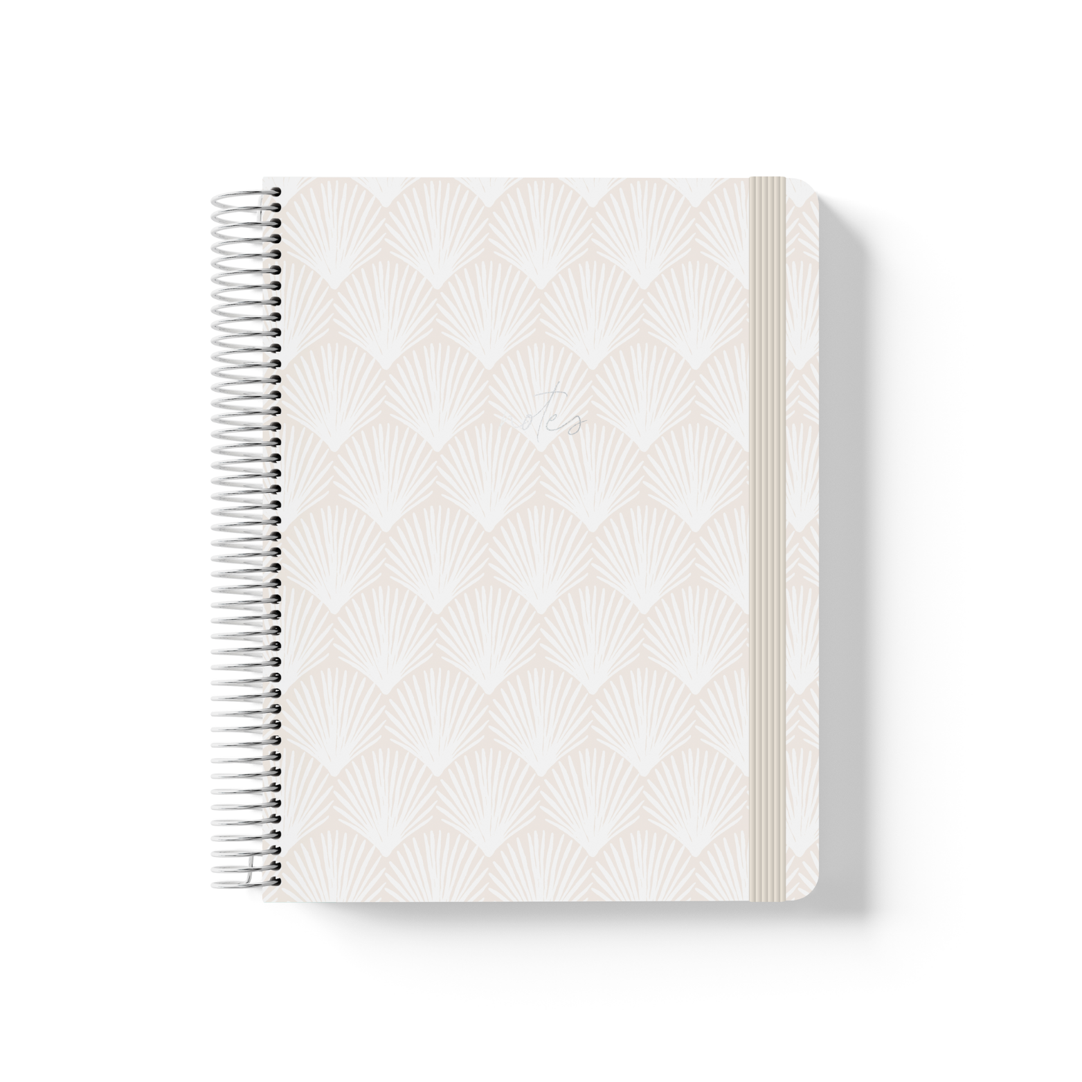 Shells spiral notebook with a repeating fan shell pattern in soft white and sand, silver coil binding, and cream elastic closure.