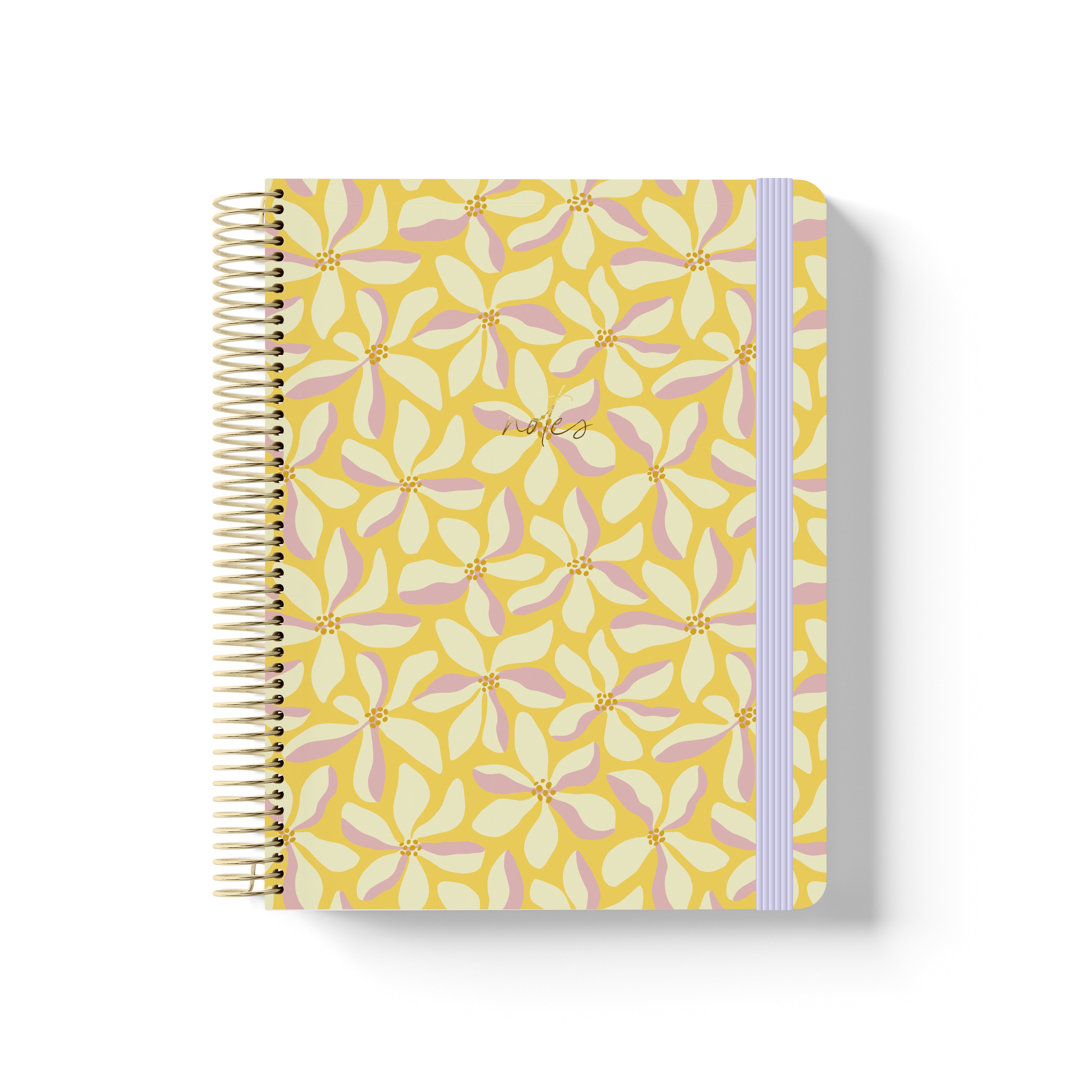 Yellow coiled notebook with gold spiral, floral petal pattern in pink and cream, lavender elastic band, and “notes” in gold script.