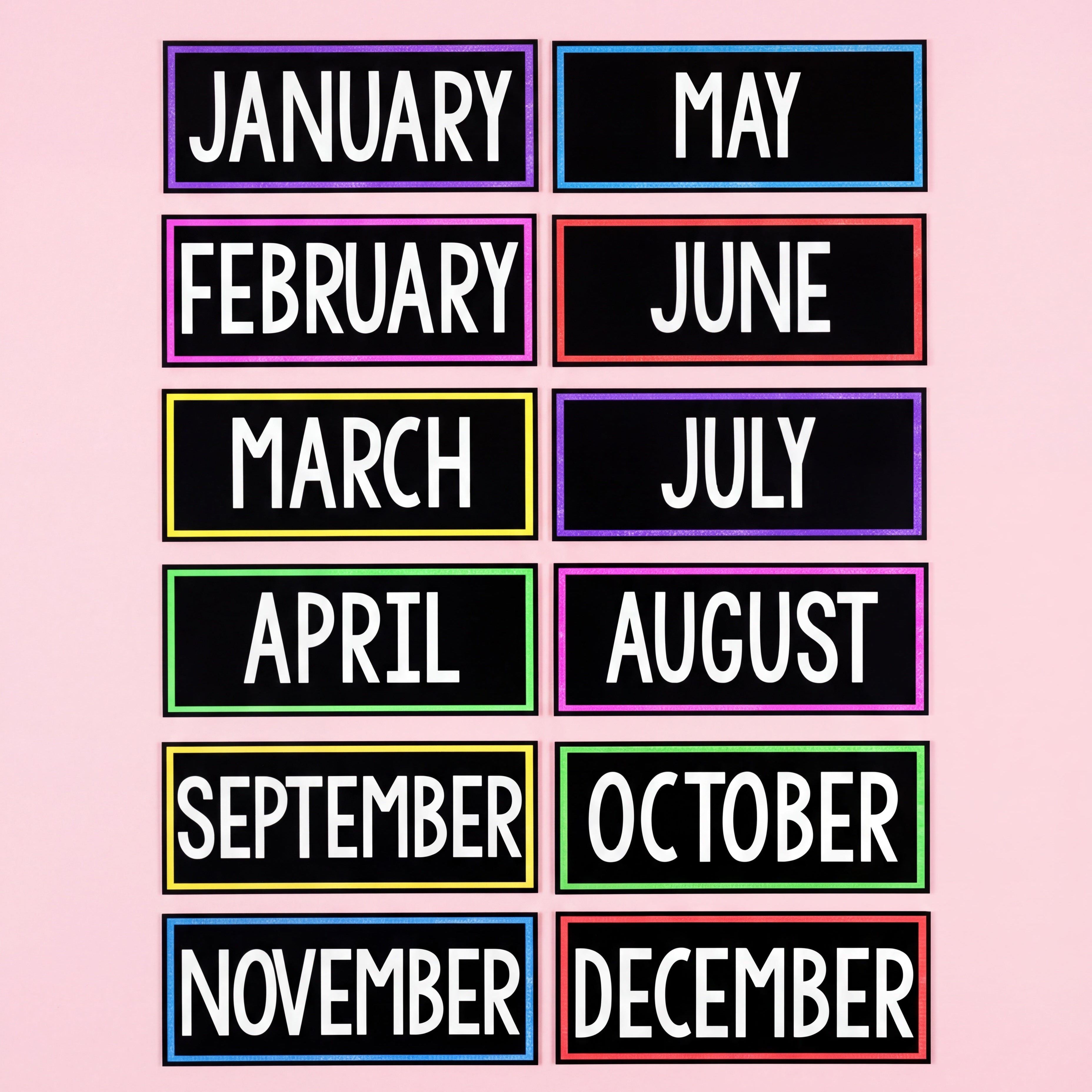 Black classroom month labels with colourful borders displaying all twelve months from January to December in bold white uppercase text, arranged in two vertical columns on a pink background.