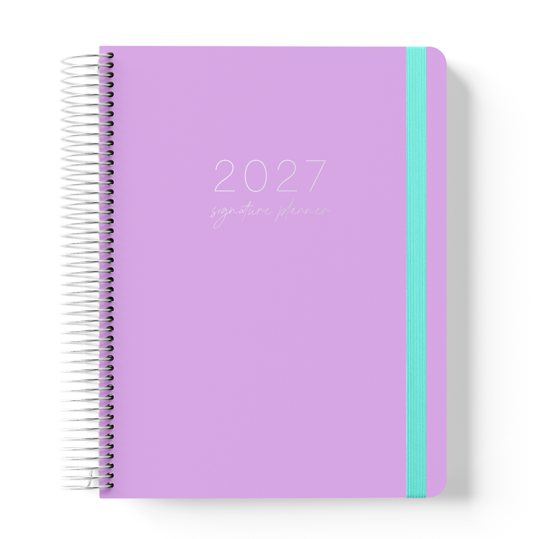 2027 Lilac Weekly Teacher Planner with lilac cover, silver coil and teal elastic on a white background.