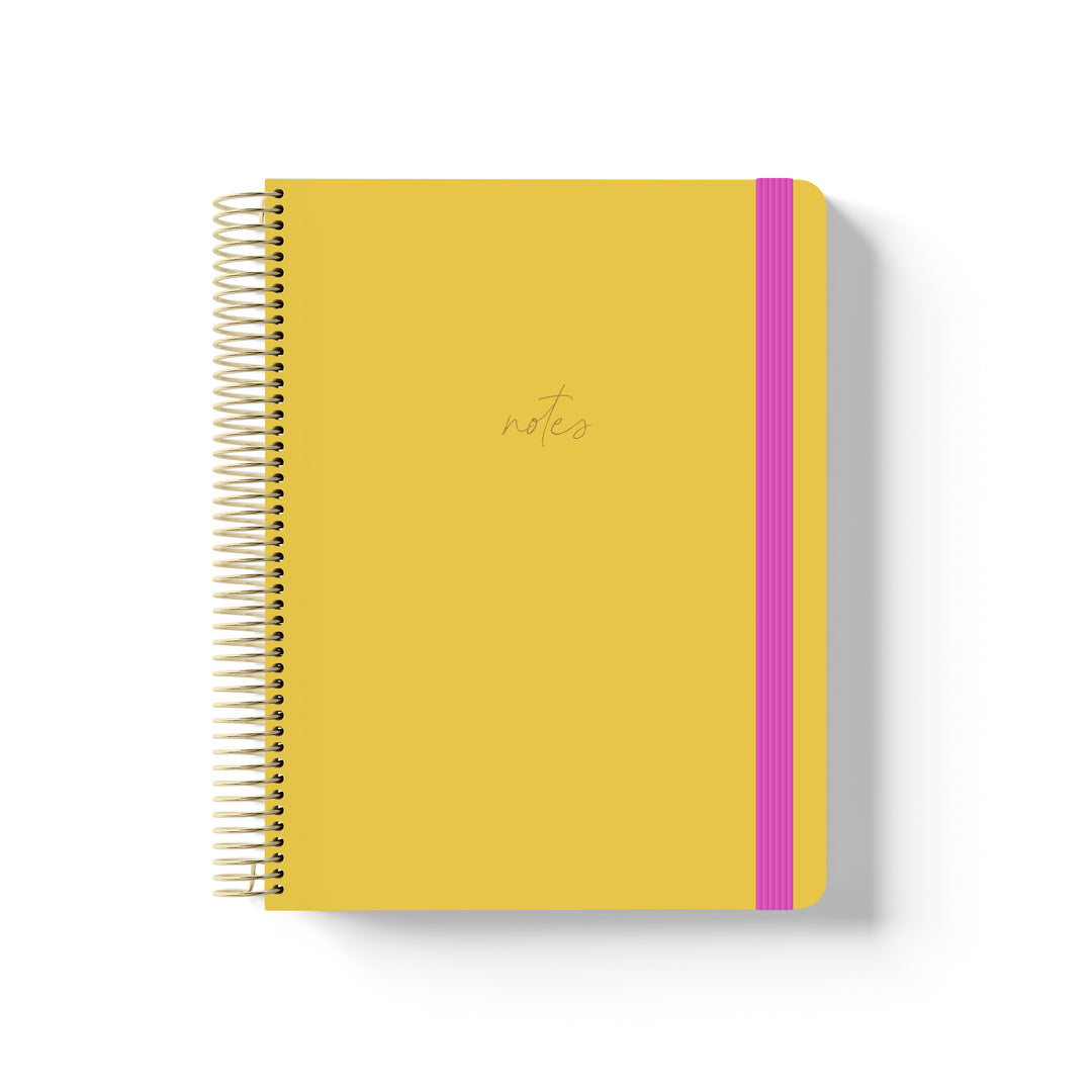 Marigold yellow coiled notebook with gold spiral binding, hot pink elastic band, and minimalist “notes” text in gold script.