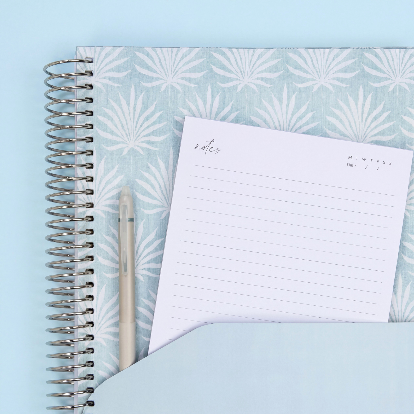 Teacher planner storage pocket with blue palm design, notes page and pen for organising lesson plans and classroom resources.