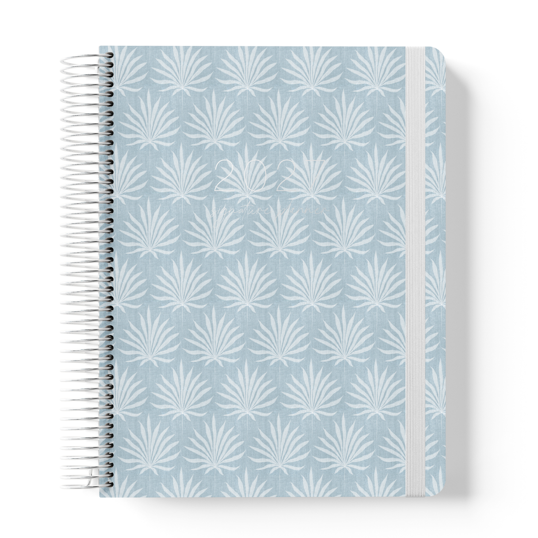 2027 teacher planner with blue palm pattern cover, silver spiral binding and elastic closure for school planning and organisation.