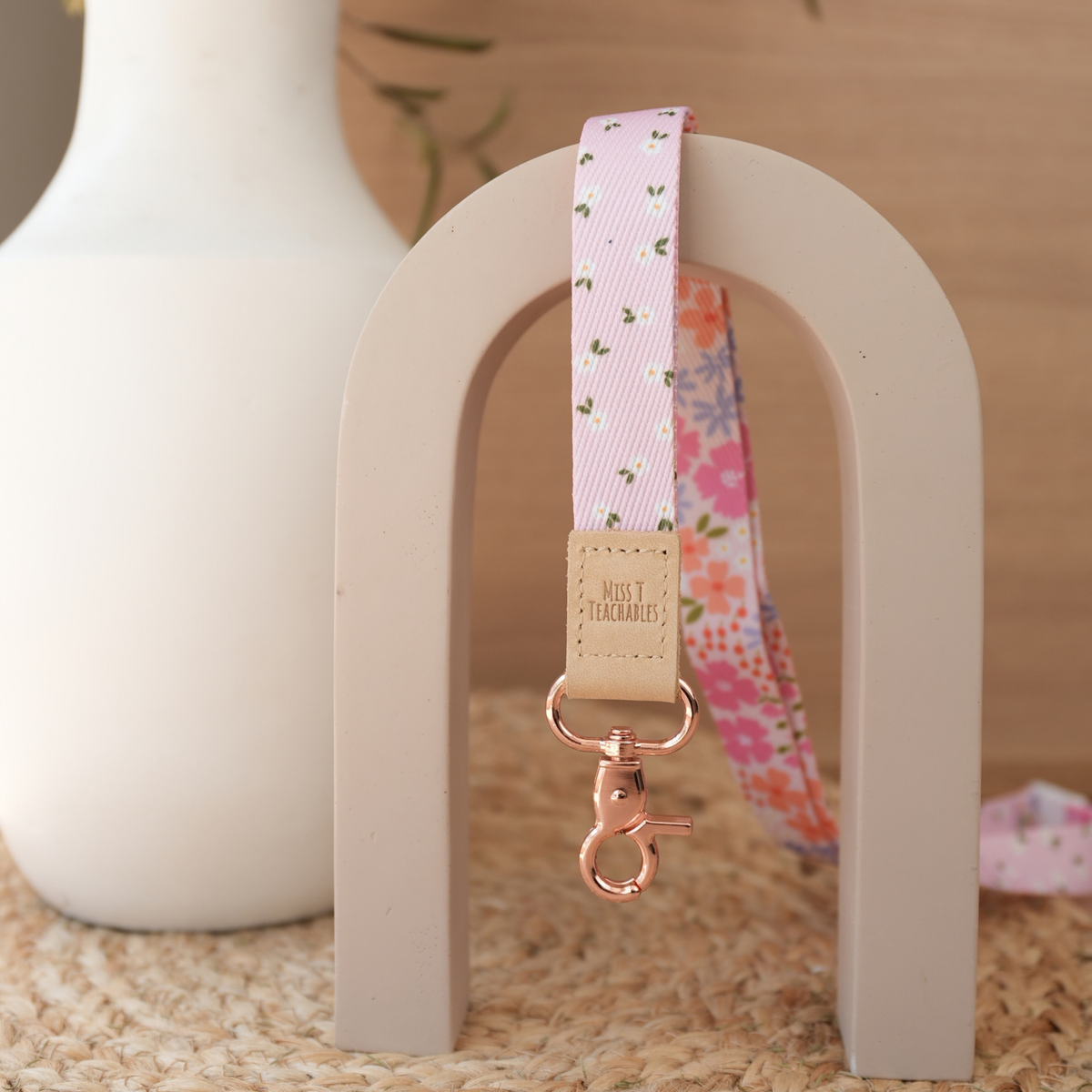 Pink Ditsy Floral teacher lanyard reversed to show the soft pink ditsy daisy print with tan leather tab