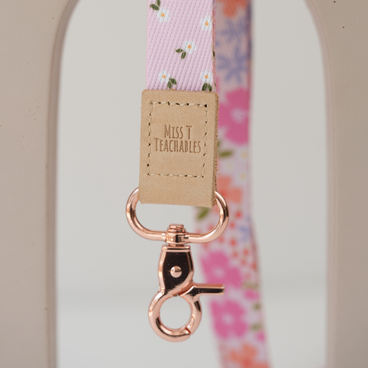 Detail of Pink Ditsy Floral reversible lanyard showing both pink floral and daisy sides