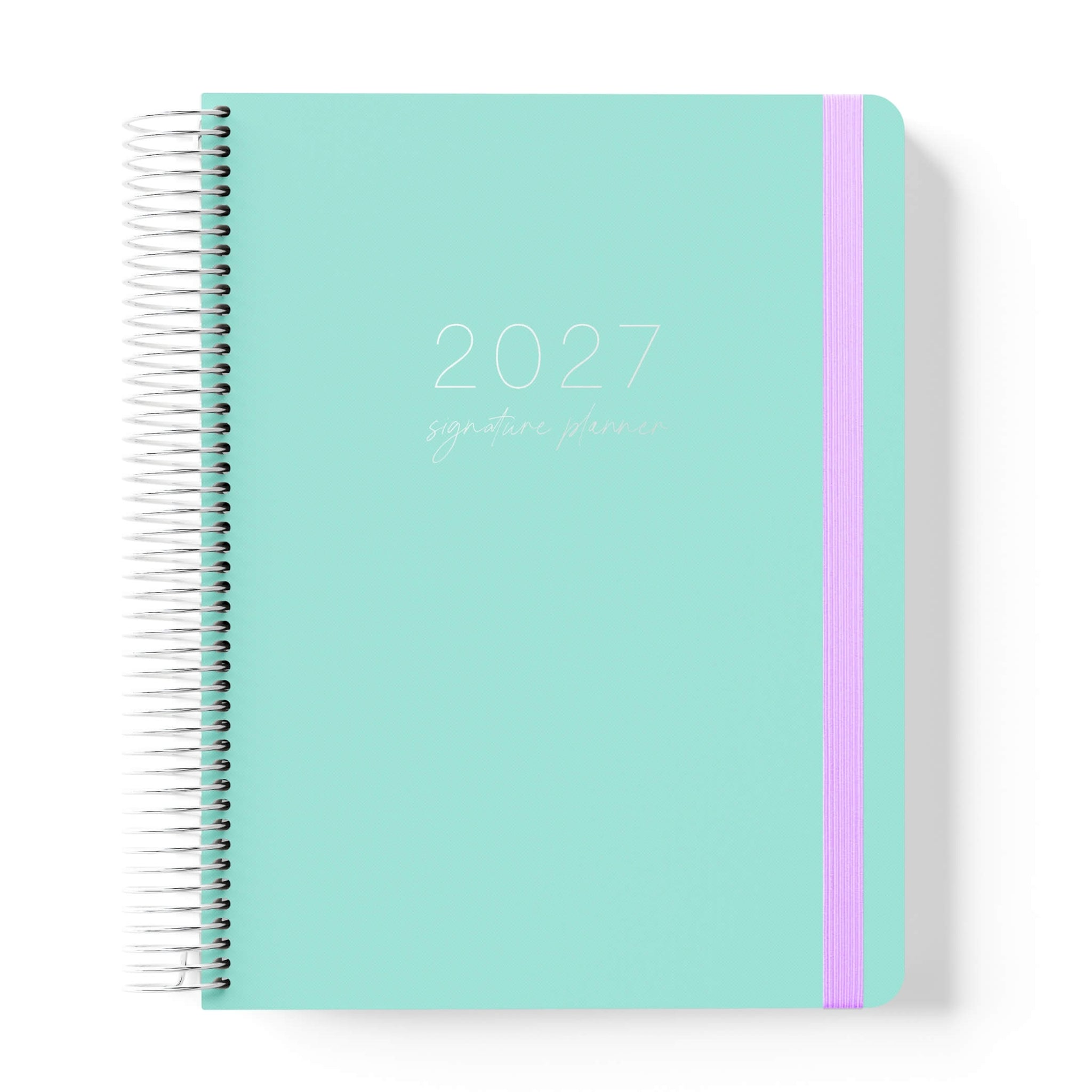 2027 Signature Planner in Seafoam with tonal text on a mint green cover, silver coil binding, and lilac elastic closure.