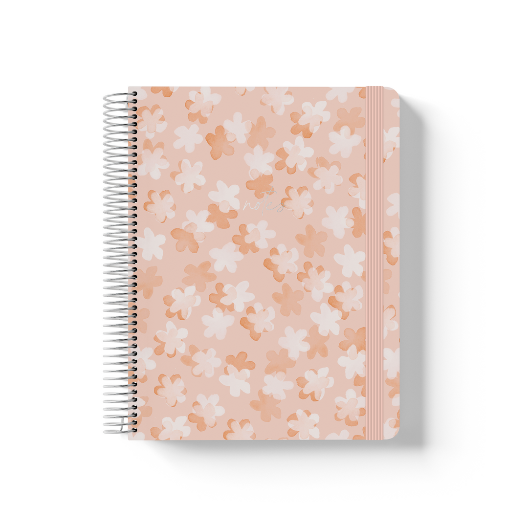 So Sweet spiral notebook with white and tan daisy pattern on blush pink, silver coil binding, and pink elastic closure.