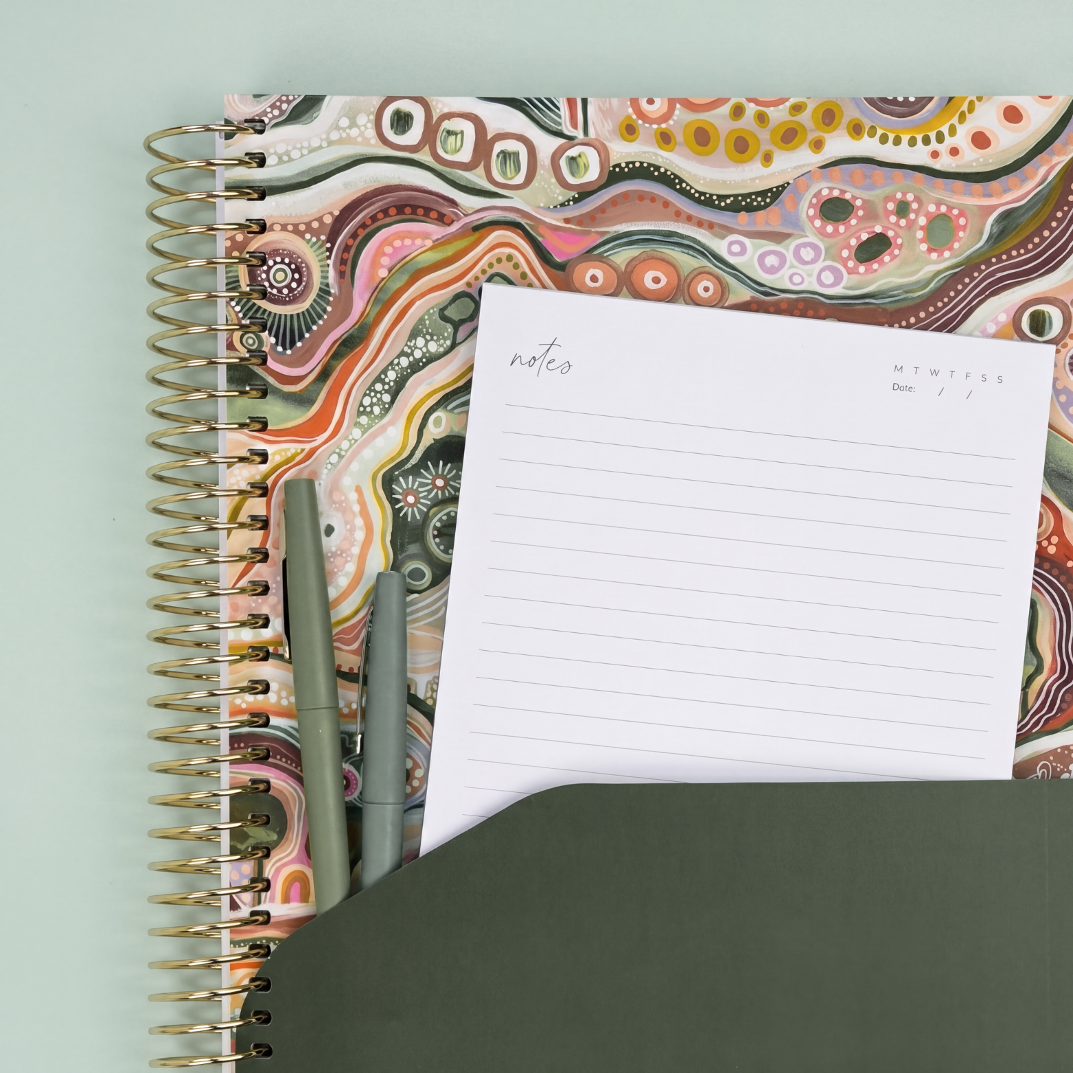2027 Sacred Grandparent Tree Daily Planner showing olive pocket sleeve with notes page and pens, gold coil on a sage background.