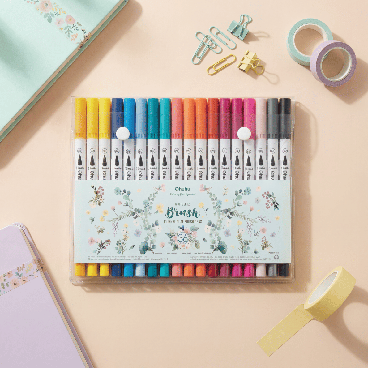 Teacher stationery flat lay with 36 colour brush pens, notebook, washi tape and clips, perfect teacher pens for classroom organisation and creative lesson planning