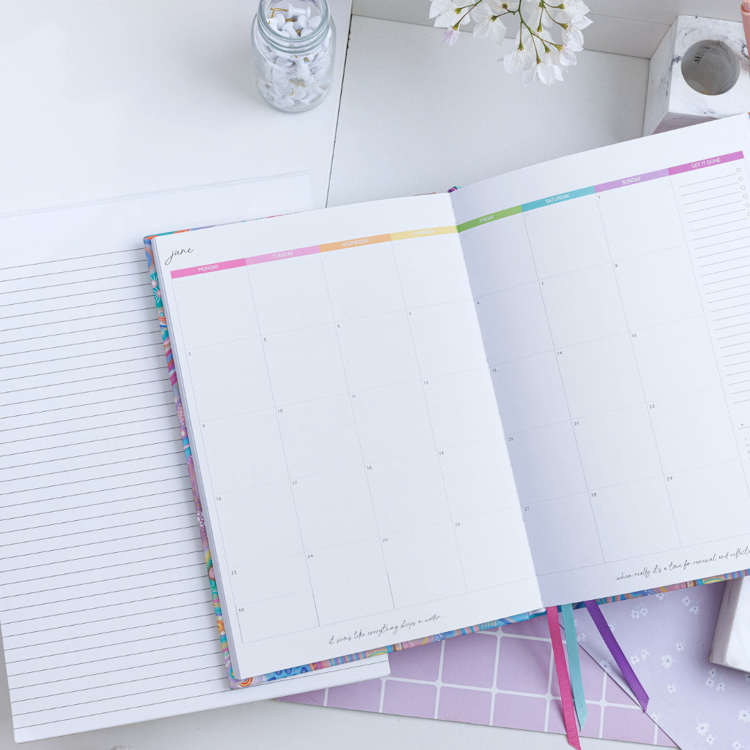 Open personal planner focusing on the left calendar page, showing 'June' at the top with weekdays in rainbow colours.