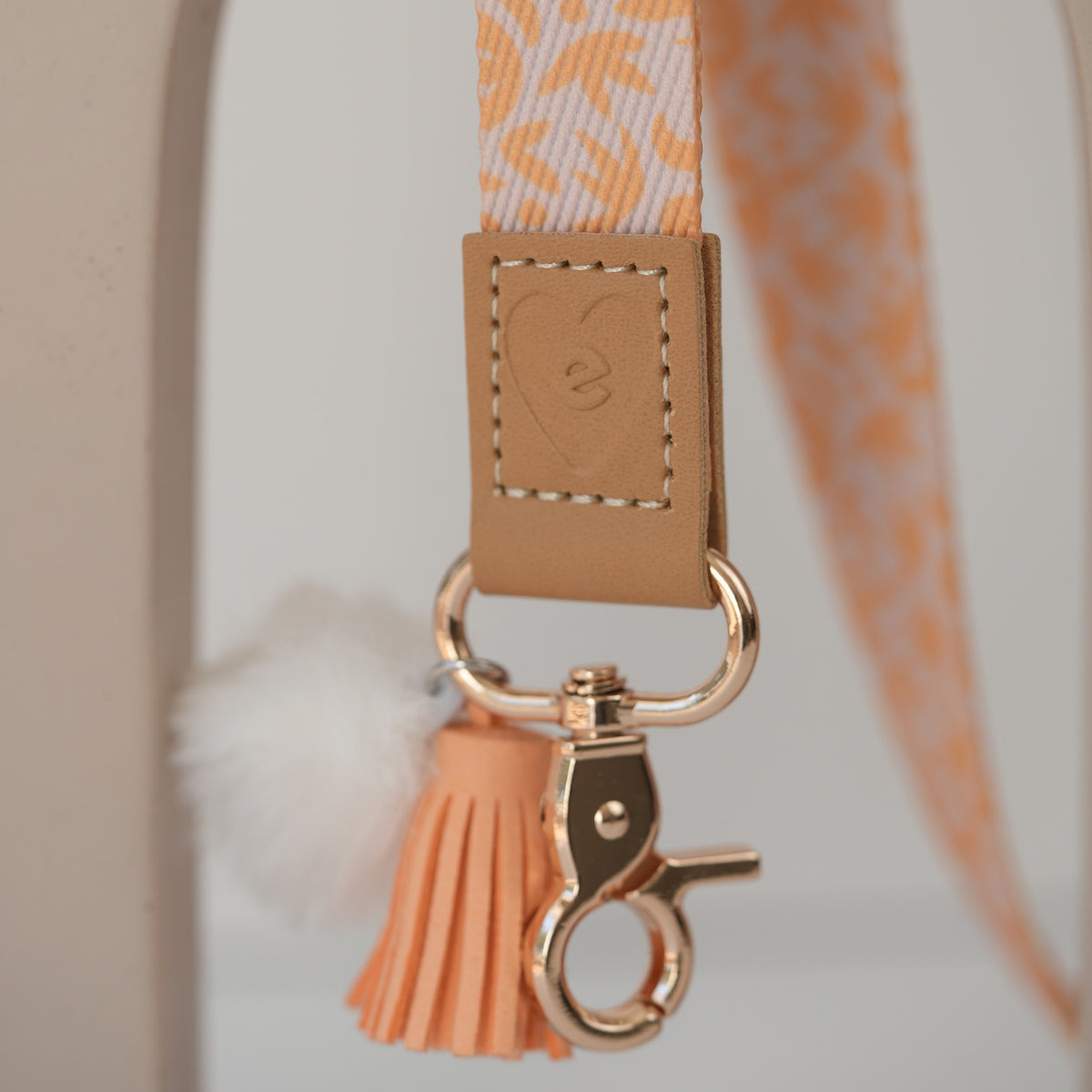 Detail of Dreamy Afternoon teacher lanyard clasp, silver hardware with white pom pom and mint tassel
