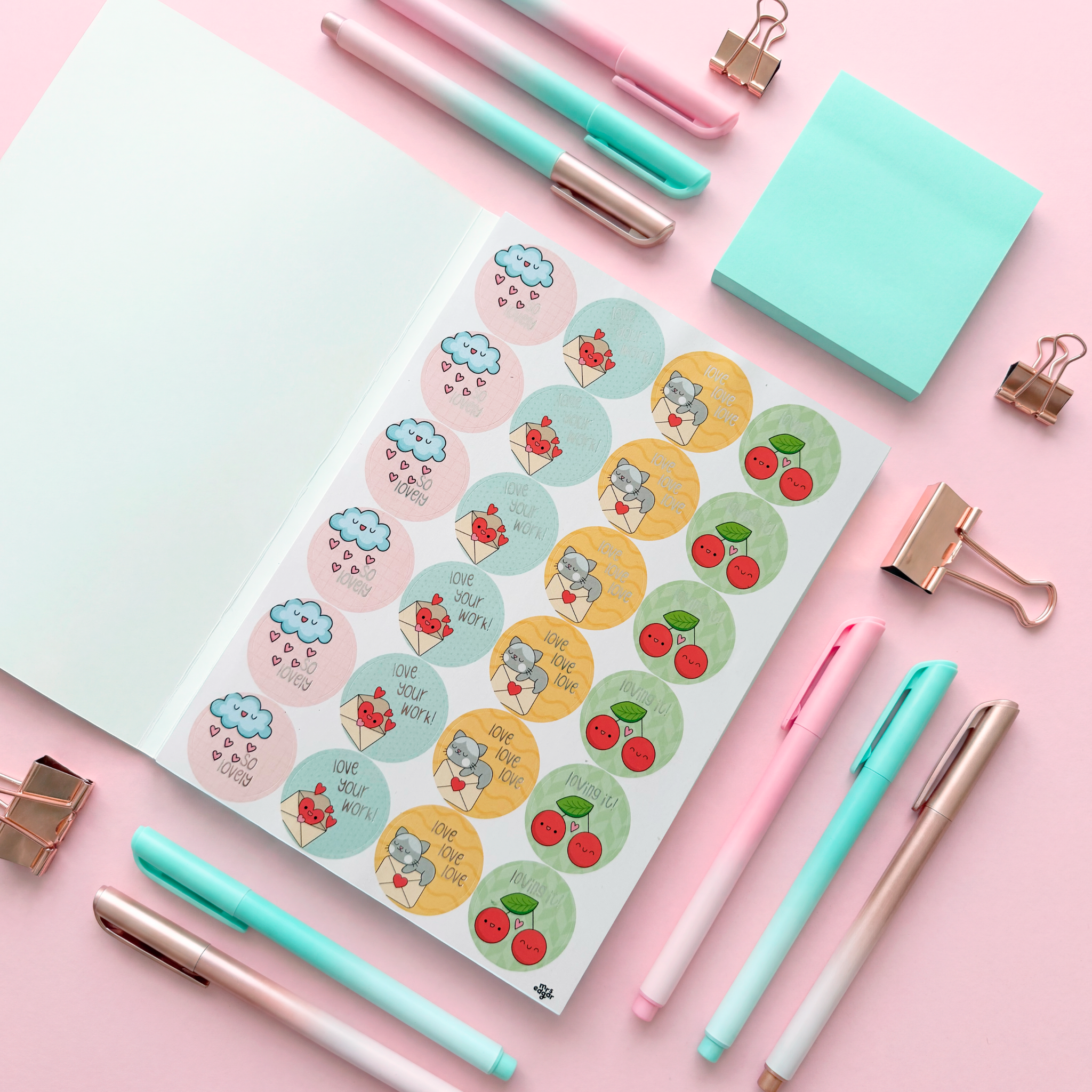 Sticker book for students open with cute reward stickers, pastel stationery flat lay with pens, clips and sticky notes