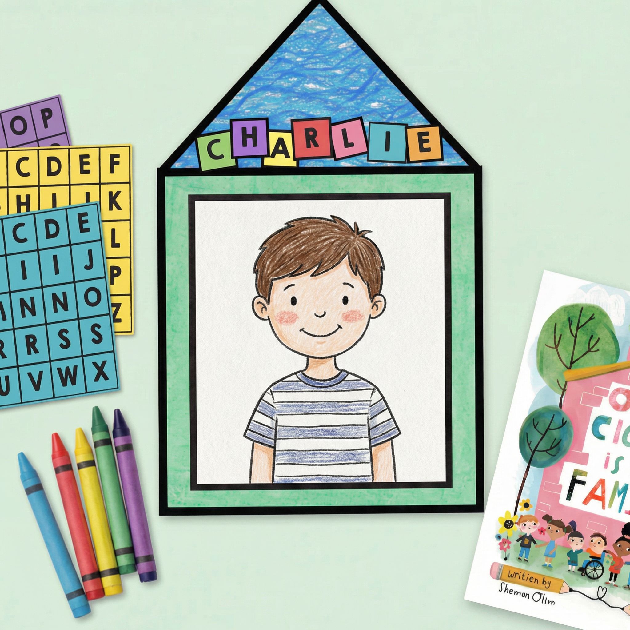 Personalised classroom portrait craft featuring a coloured drawing of a smiling child inside a house-shaped frame with the name “Charlie” spelled out in colourful letter tiles, surrounded by crayons and learning materials.