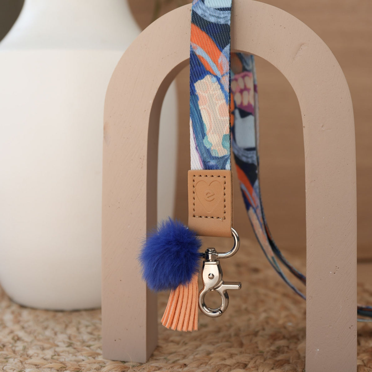 Jewels teacher lanyard by Claire Desjardins full length, silver clasp, deep blue pom pom and orange tassel