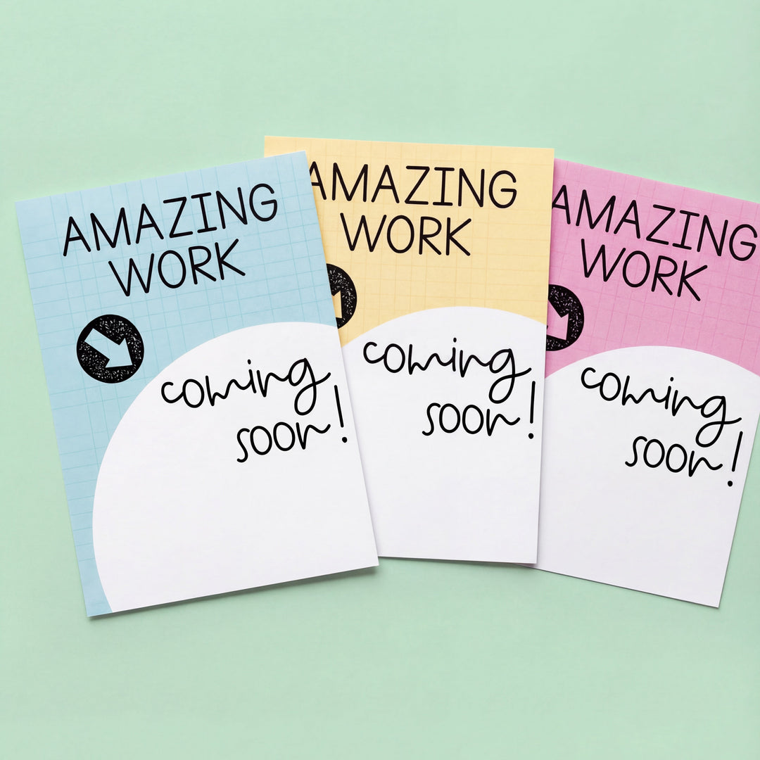 Three "Amazing Work Coming Soon" posters in soft pastel colours (blue, yellow, and pink) with a circular blank space for displaying student work. Art supplies and craft decorations are scattered at the bottom.